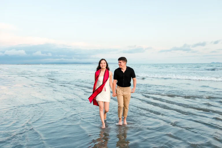 Graduate and Friend Walking on the Beach