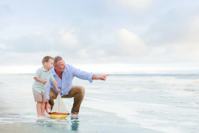 Father and Son on the Beach with Sailboat