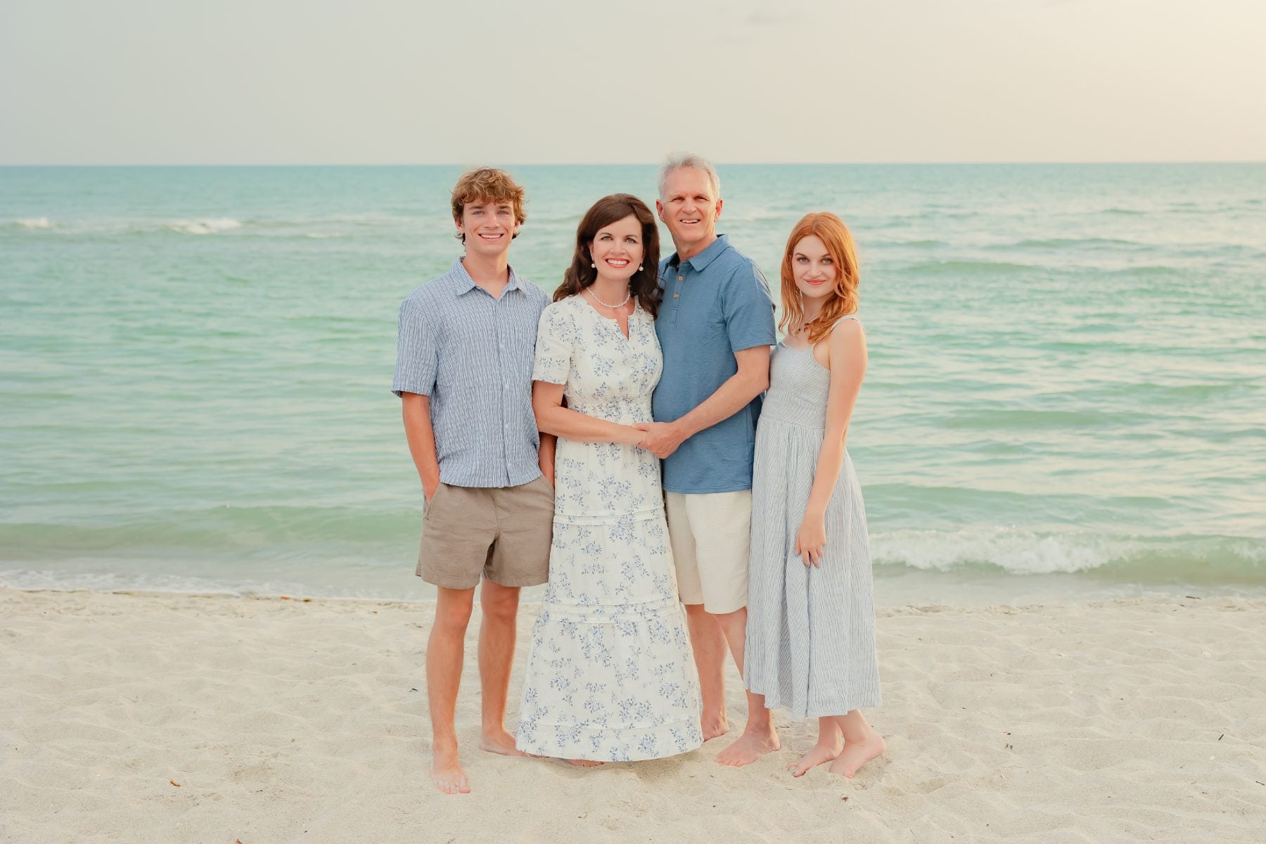 Family of four holds hands on Captiva Island beach