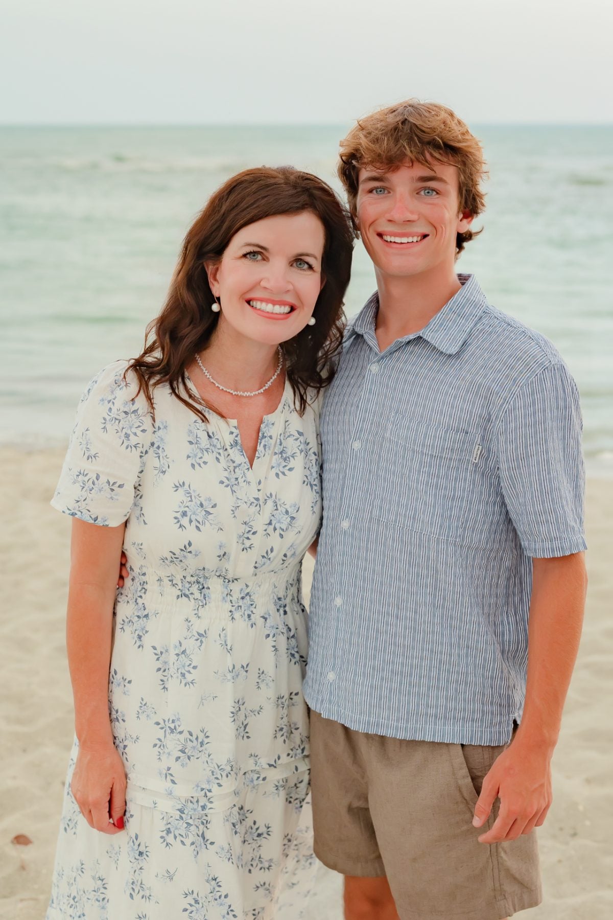Mother and son pose together on Florida beach shoreline