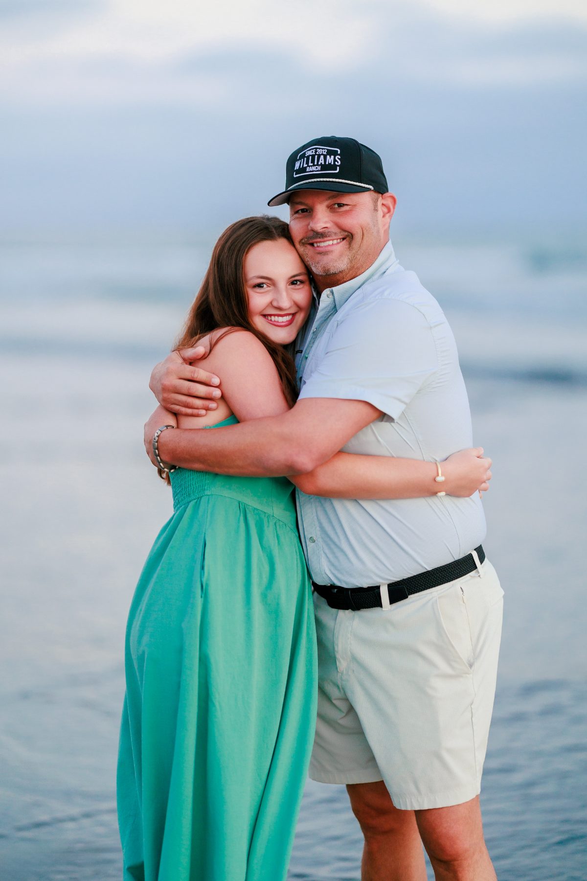 Couple hugs on Coronado Beach at sunset