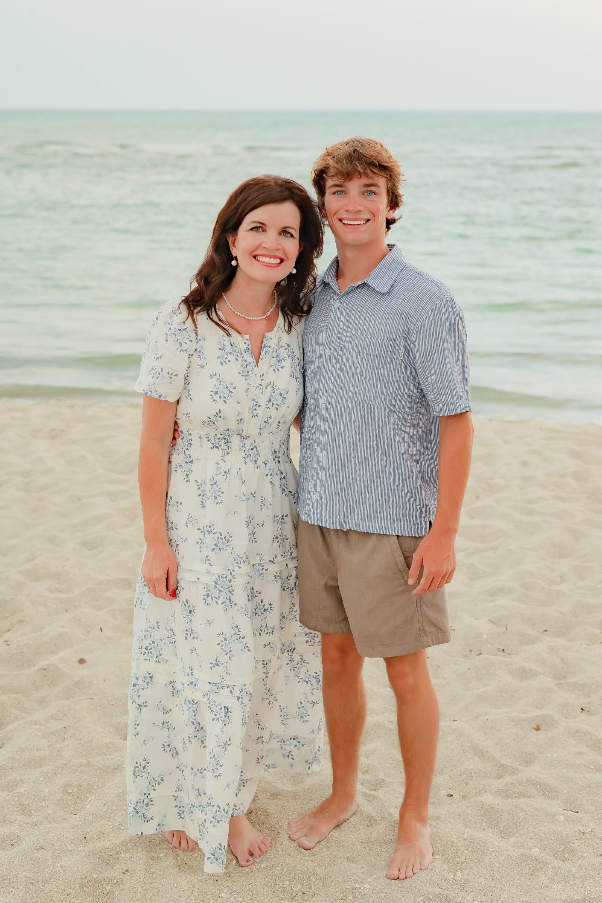 Mother and son embrace during a family beach portrait session