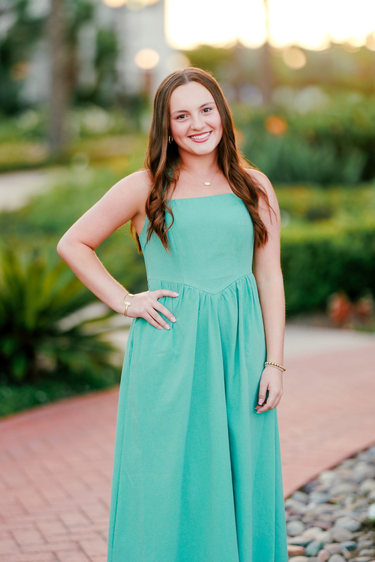 Teen girl in teal dress poses for San Diego senior portraits