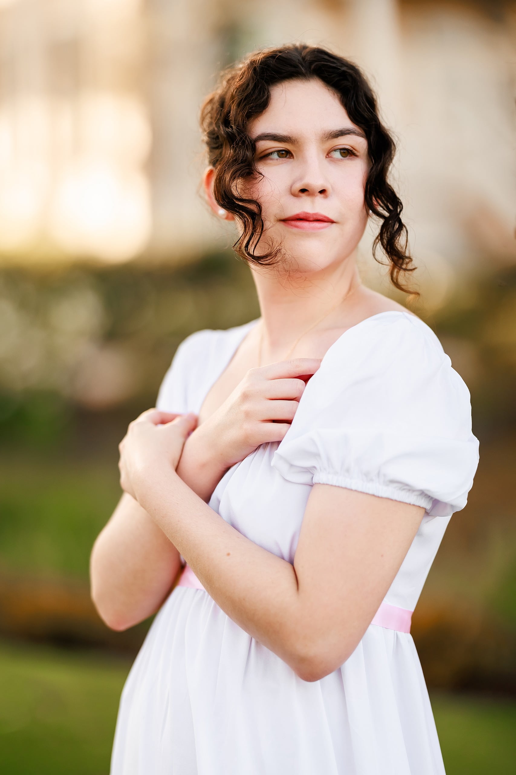 Amanda Fagan’s Love, Jane — 03 Woman in white dress with arms crossed, looking directly at camera