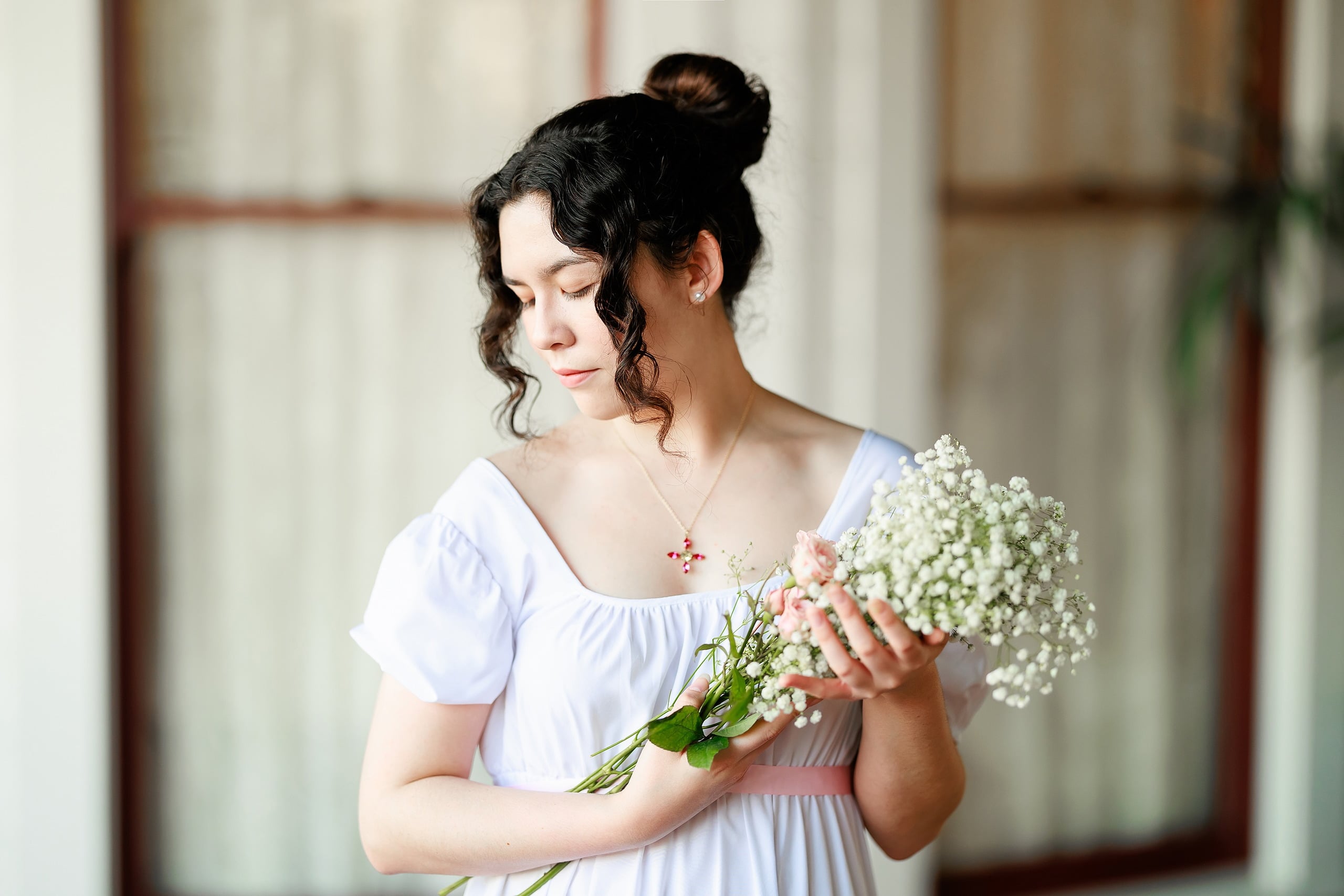 Amanda Fagan’s Love, Jane — 10 Woman in white dress holding white baby's breath, looking down at camera