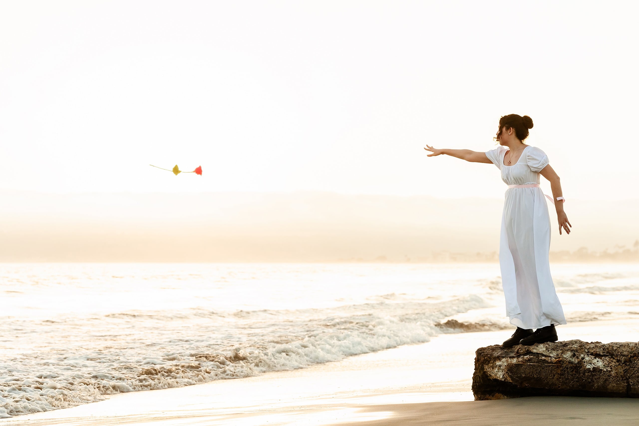 Amanda Fagan’s Love, Jane — 14 Woman in white dress on beach with arm outstretched holding ribbons