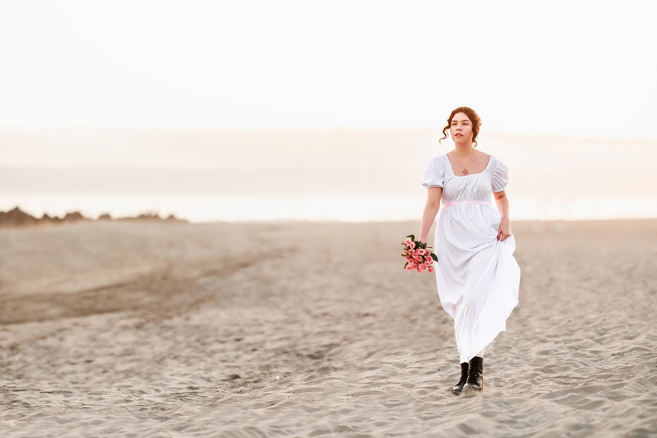 Amanda Fagan’s Love, Jane — 23 Woman in white dress walking along beach carrying colorful bouquet at sunset