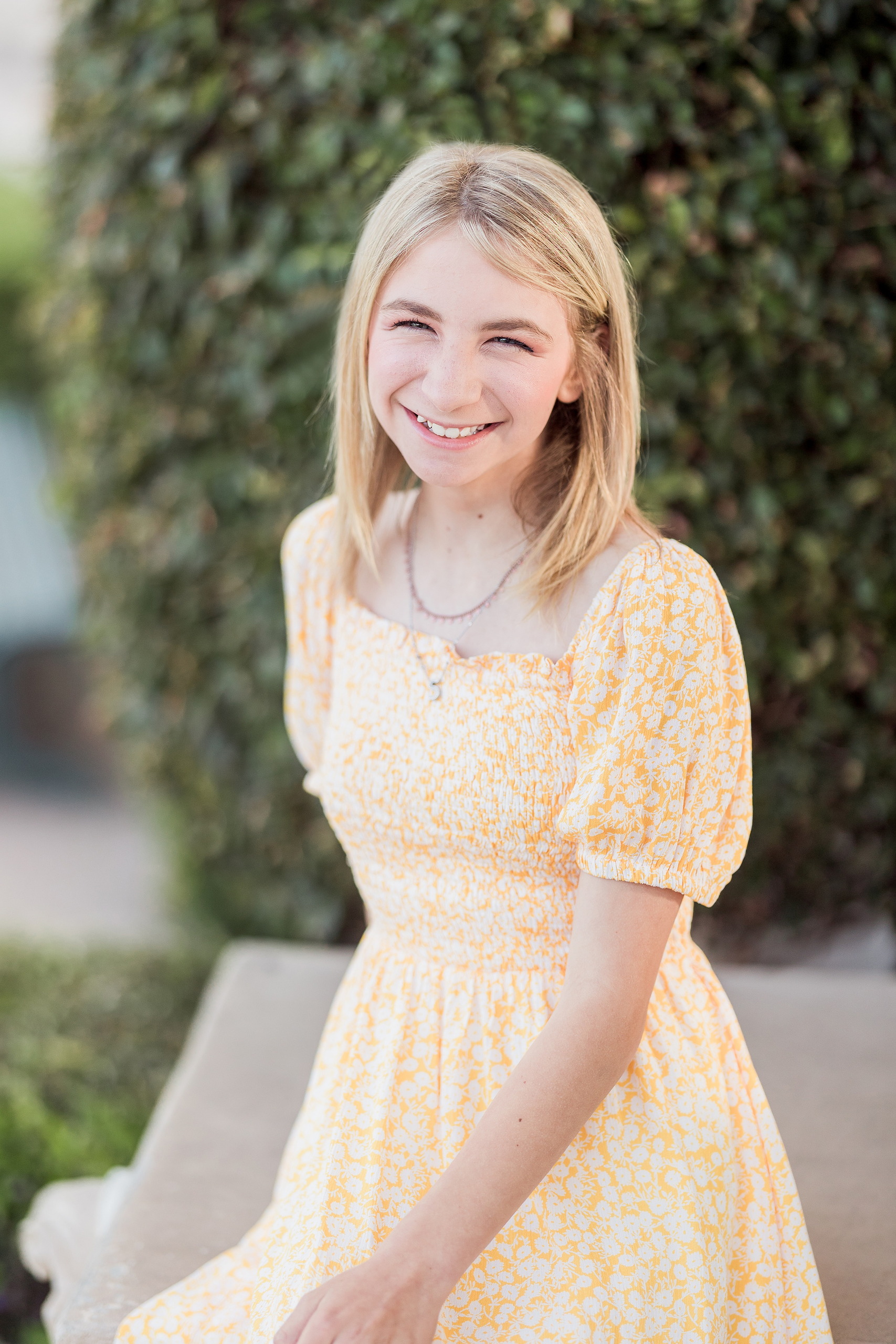 Balboa Park Family Portraits San Diego — 04 Teen girl smiling brightly with green foliage behind at Balboa Park