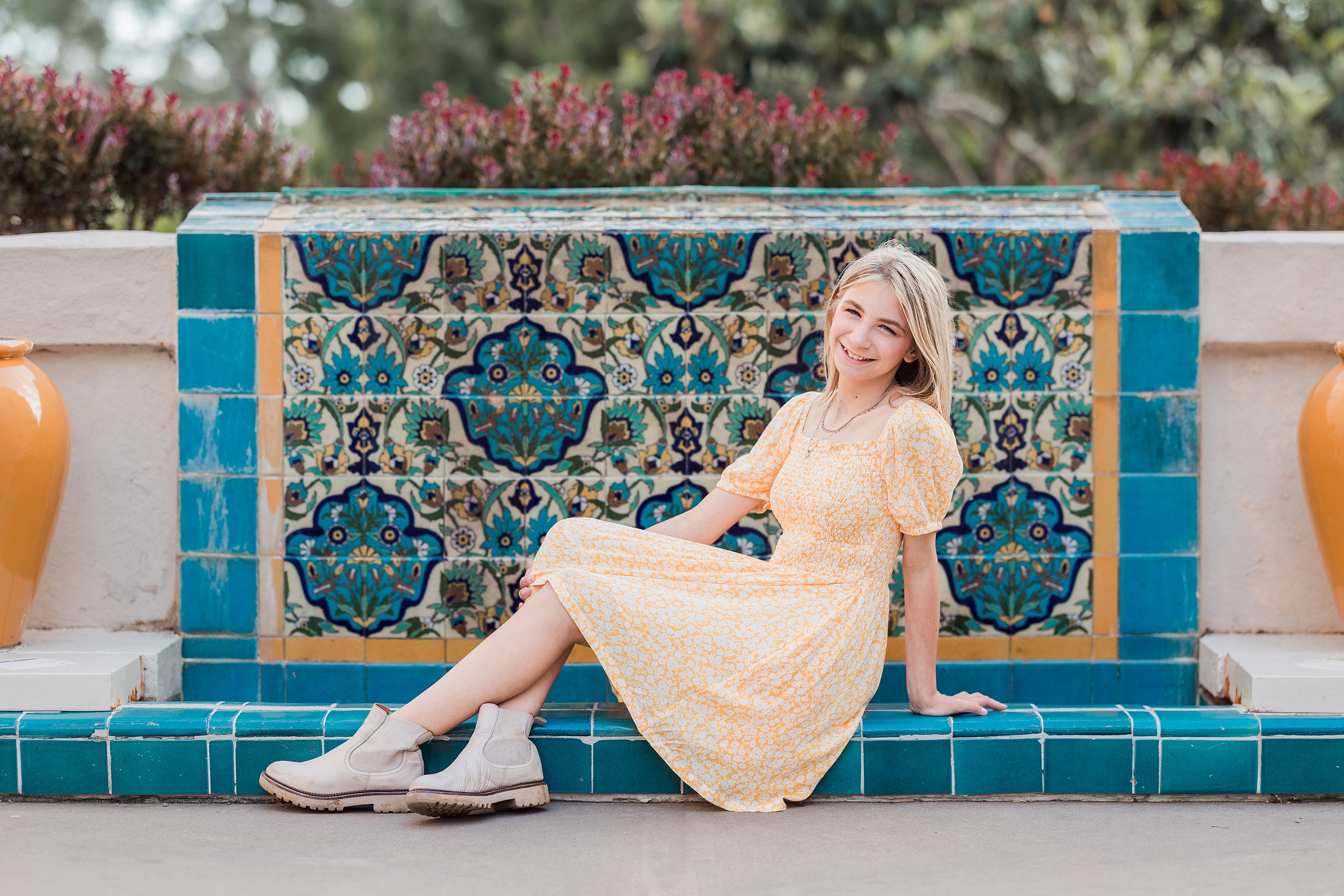 Balboa Park Family Portraits San Diego — 10 Sophie and her mom sitting on grass with arches at Balboa Park