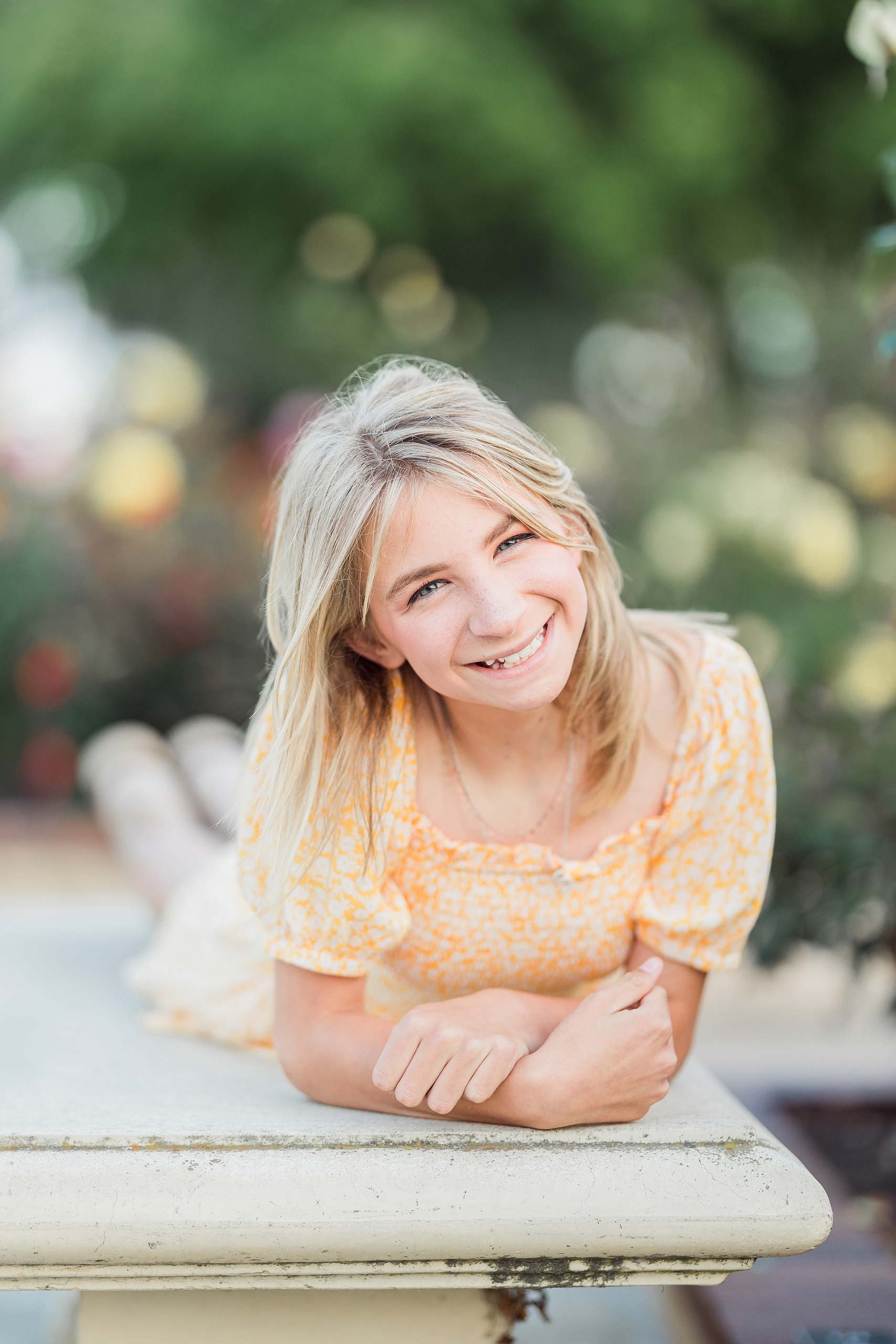 Balboa Park Family Portraits San Diego — 22 Teen girl kneeling on grass in blooming rose garden at Balboa Park