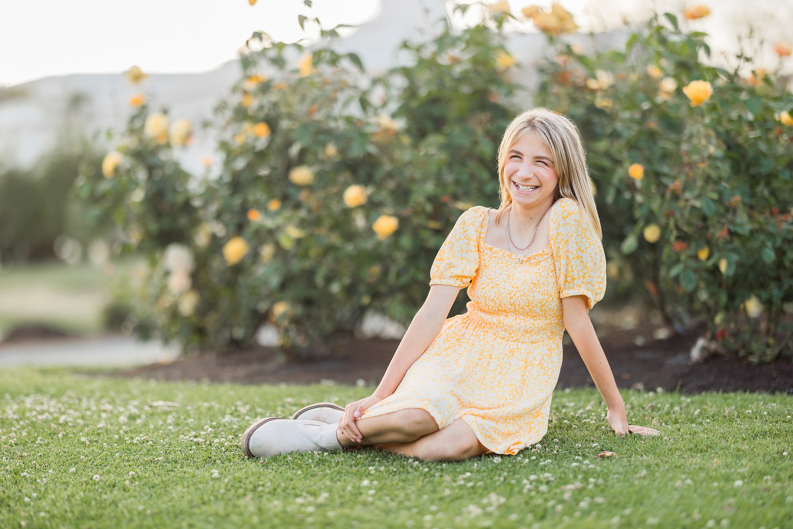 Balboa Park Family Portraits San Diego — 24 Sophie and her mom sitting together on wooden boardwalk with beach behind
