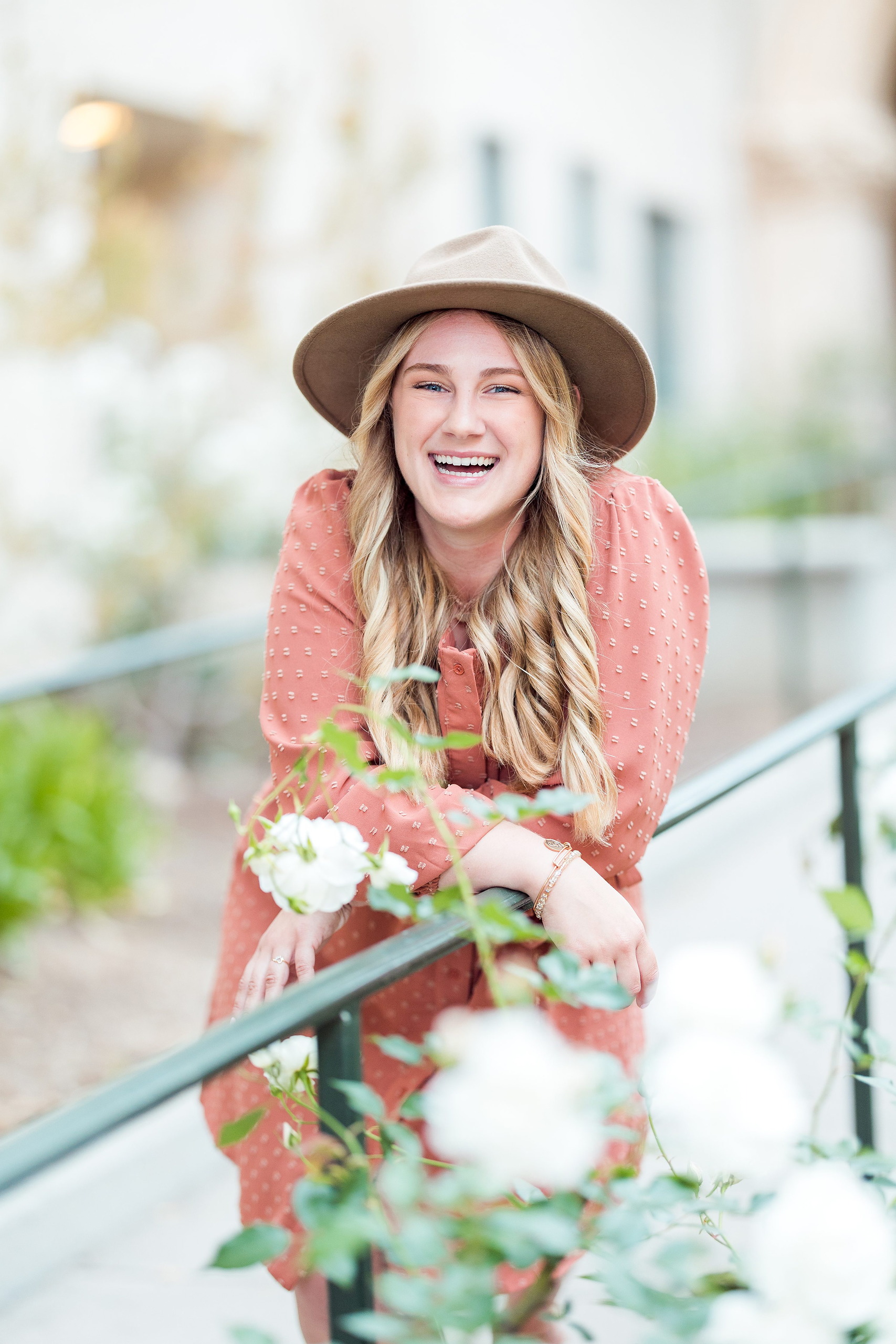 Balboa Park Senior Photography Session — 14 Senior in blue dress hugging large stone column with arched structures behind