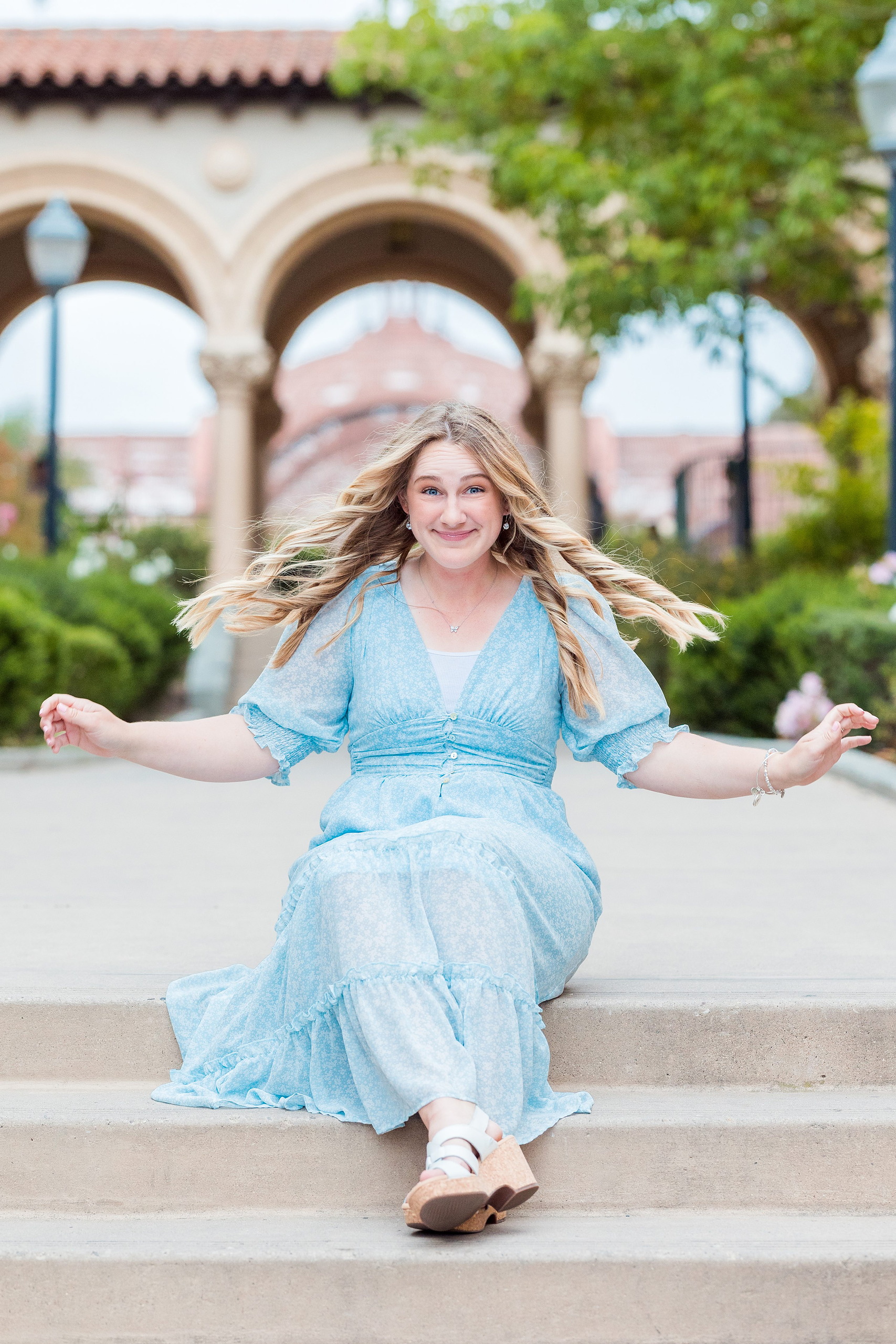 Balboa Park Senior Photography Session — 17 Senior in light blue dress on grass near pink flower beds at Balboa Park