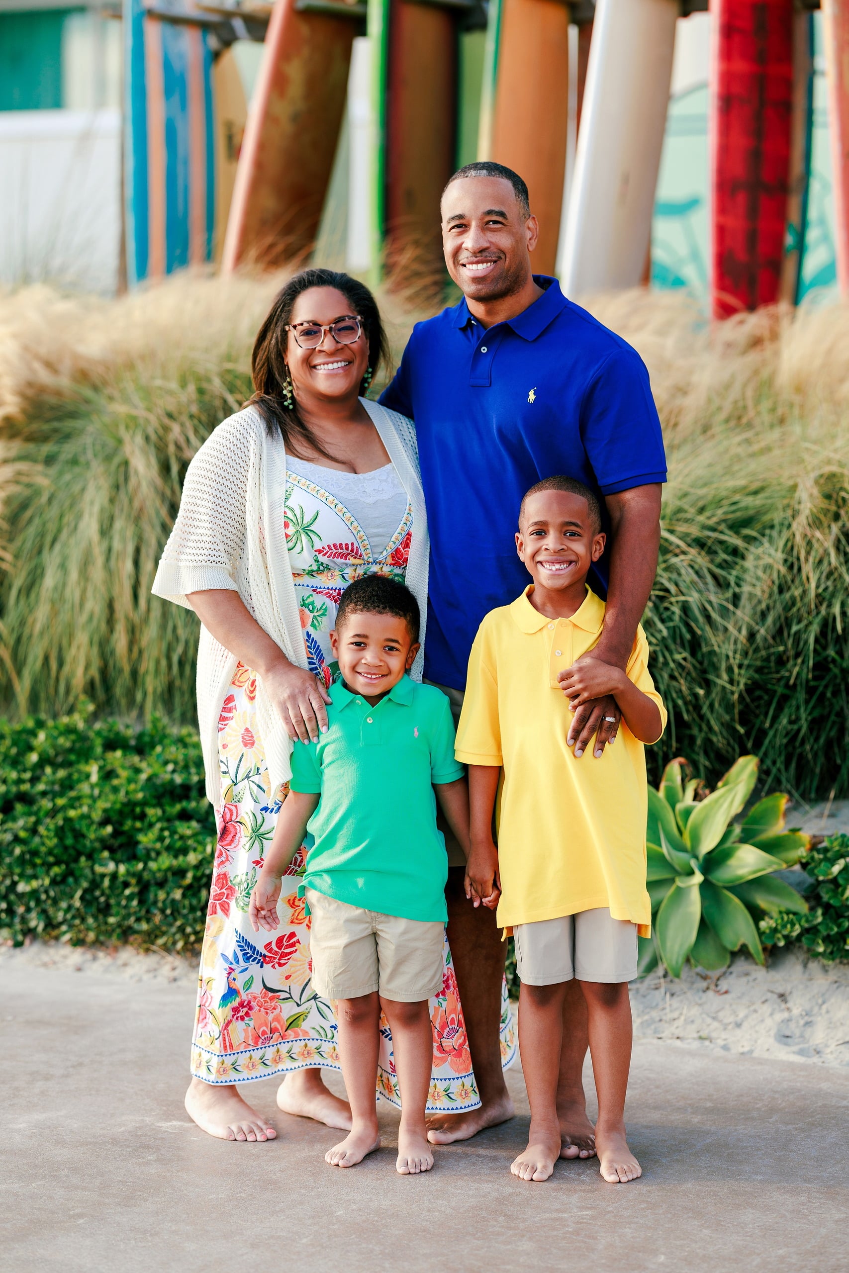 Because Time Flies: Family Photos on Coronado — 01 Michelle, Dion, and their two sons stand near colorful surfboards on Coronado