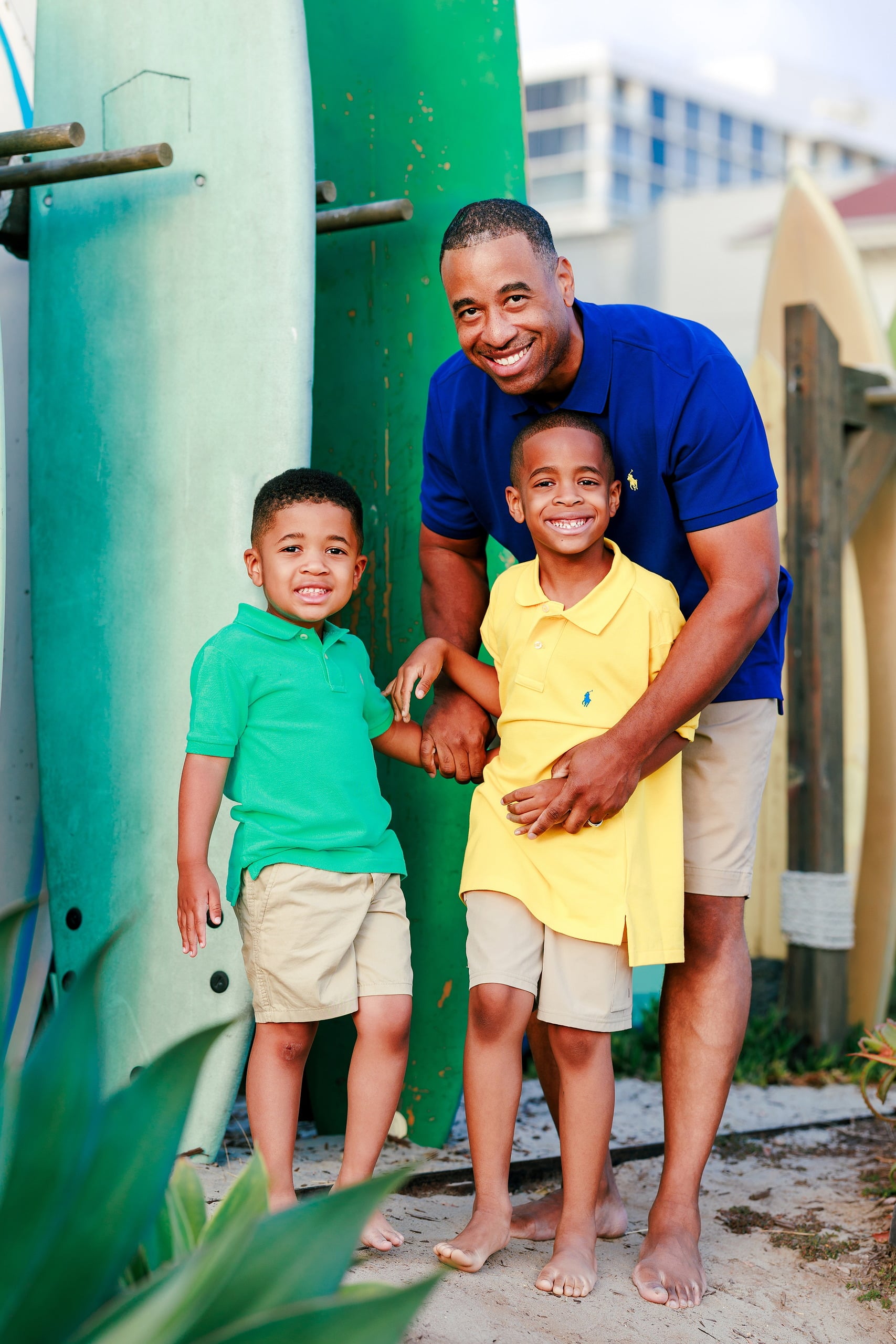 Because Time Flies: Family Photos on Coronado — 04 Dion with both sons by turquoise and green beach structures