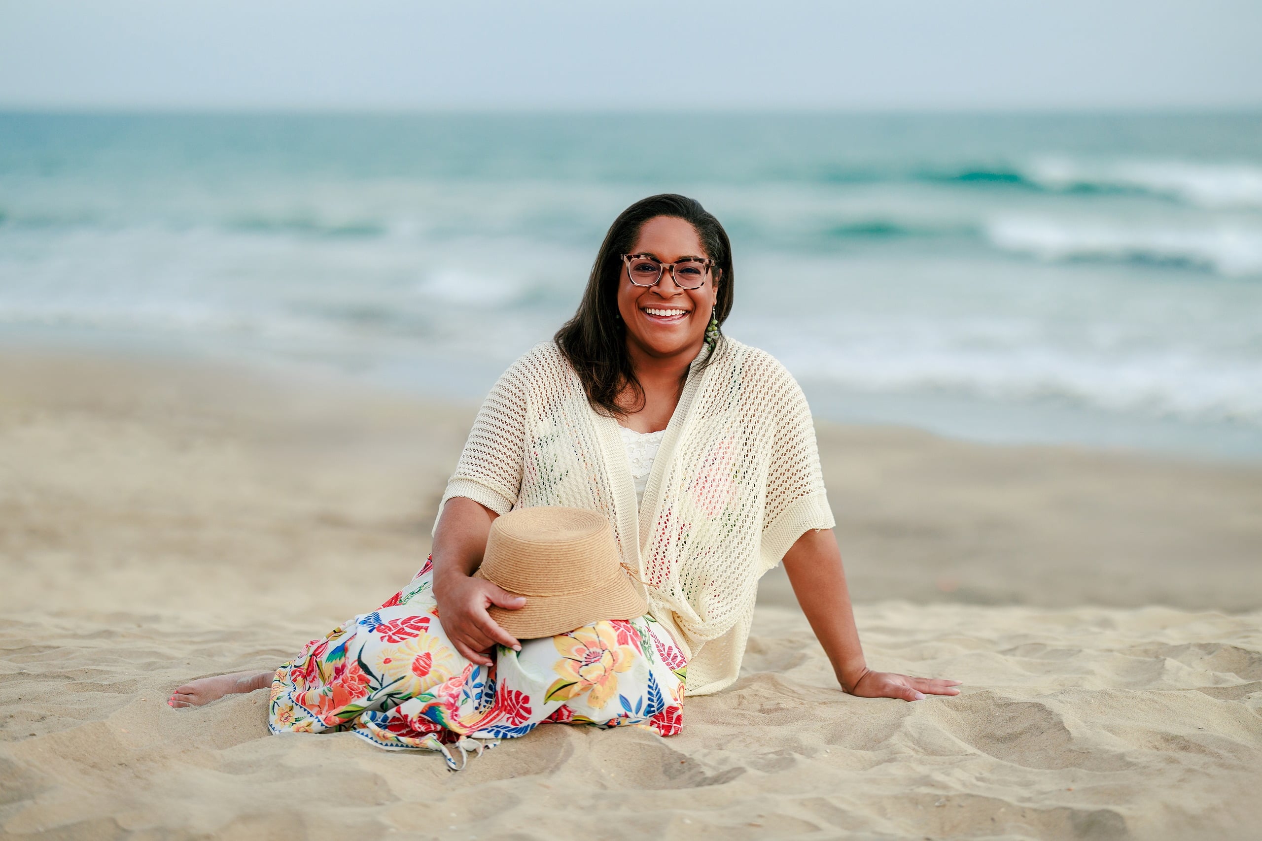 Because Time Flies: Family Photos on Coronado — 10 Michelle sits in the sand wearing a straw hat on Coronado beach