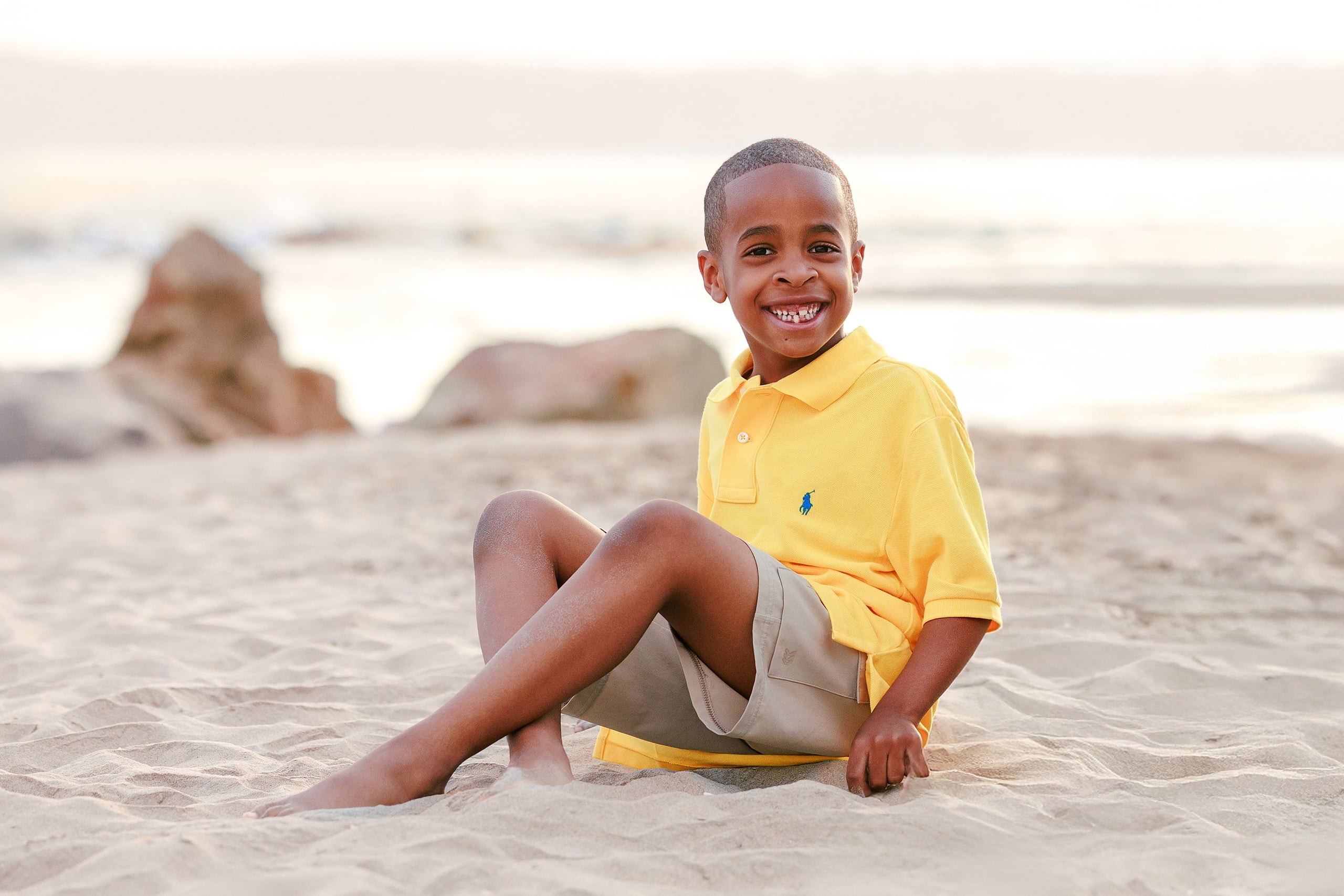 Because Time Flies: Family Photos on Coronado — 13 Older son sits alone on the sand in his yellow shirt at Coronado