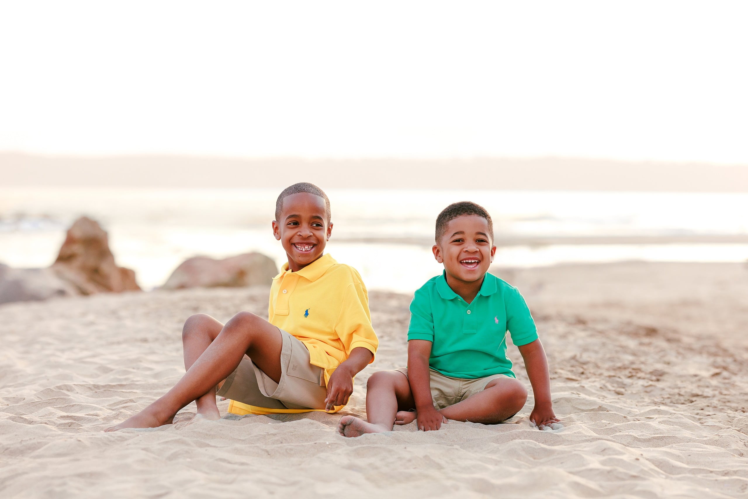 Because Time Flies: Family Photos on Coronado — 14 Both sons sit together smiling on the sand at Coronado beach