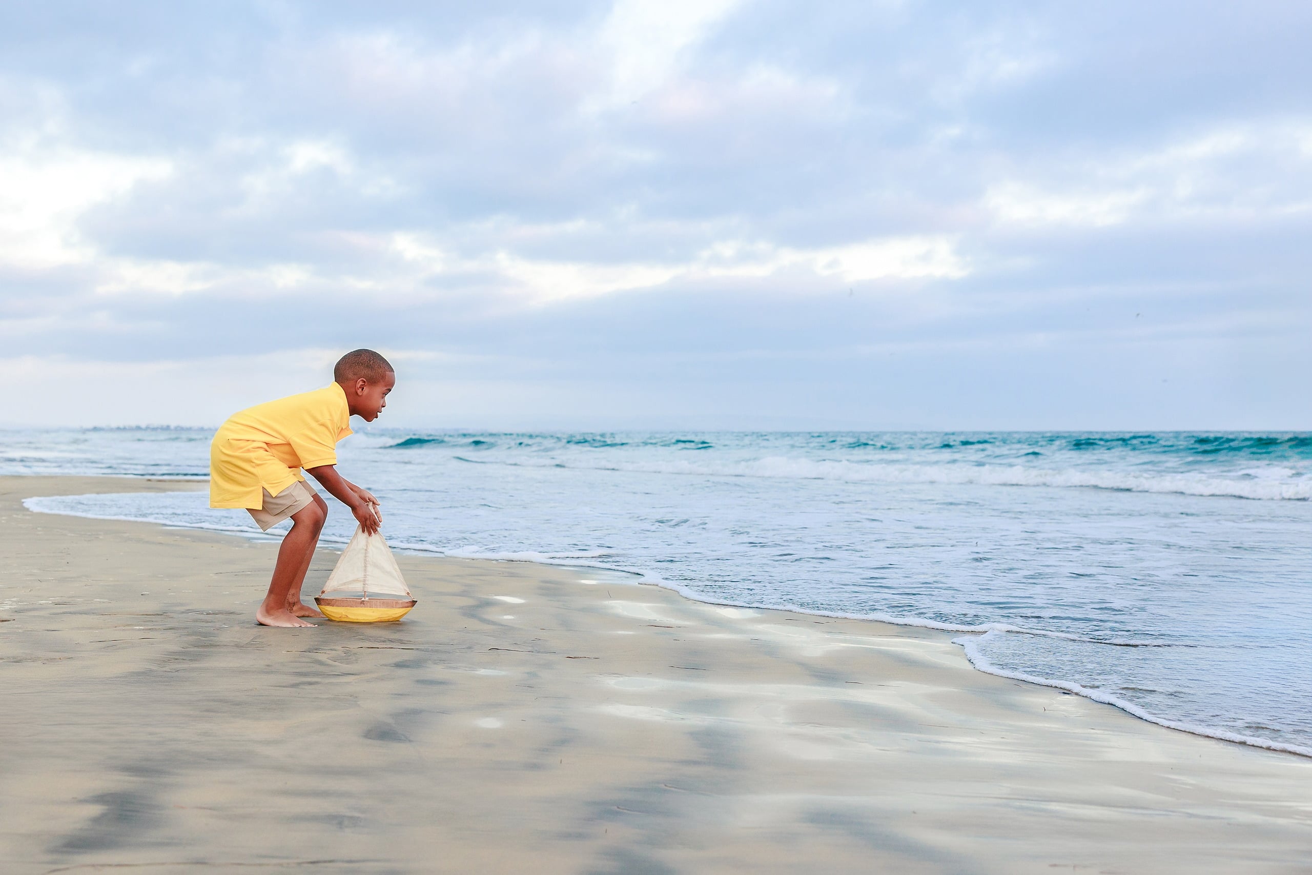 Because Time Flies: Family Photos on Coronado — 23 Younger son plays with a toy sailboat in the shallow water at Coronado