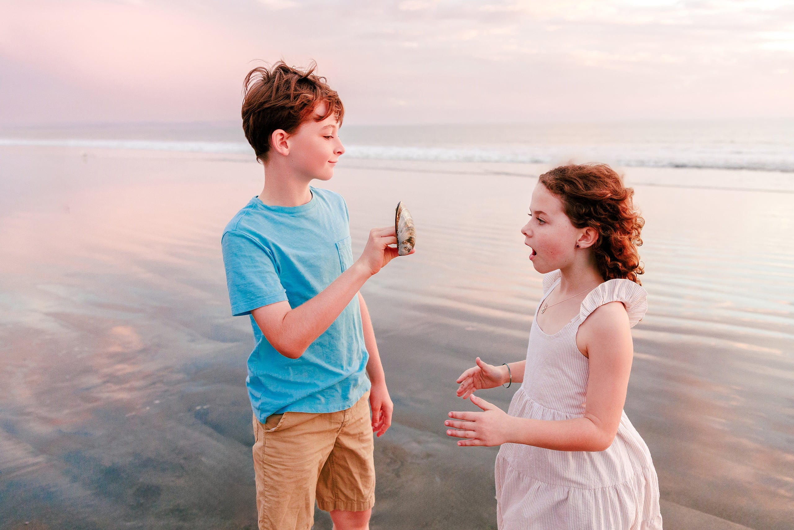 Behind the Scenes of Grammy Judy’s 80th Birthday Session: An Interview with Wendy — 28 Boy and girl examine a seashell together on beach during golden sunset hour