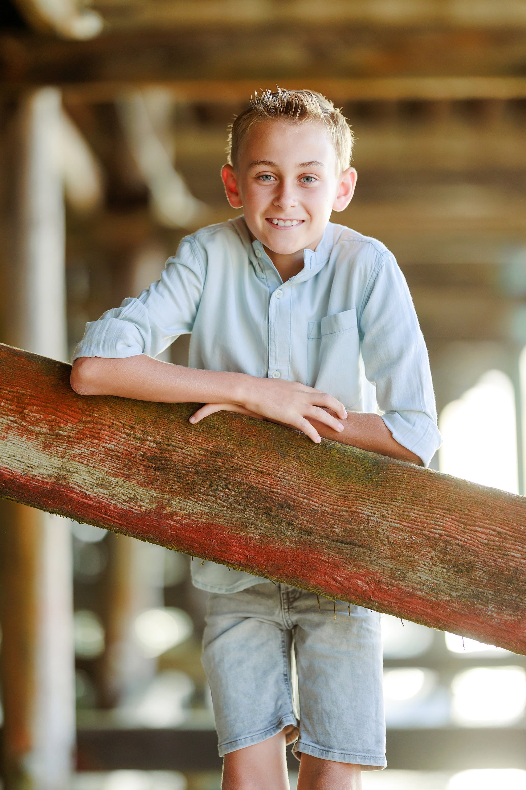 Butlers on the Beach — 03 Boy in light blue shirt leaning on weathered rail at Crystal Pier