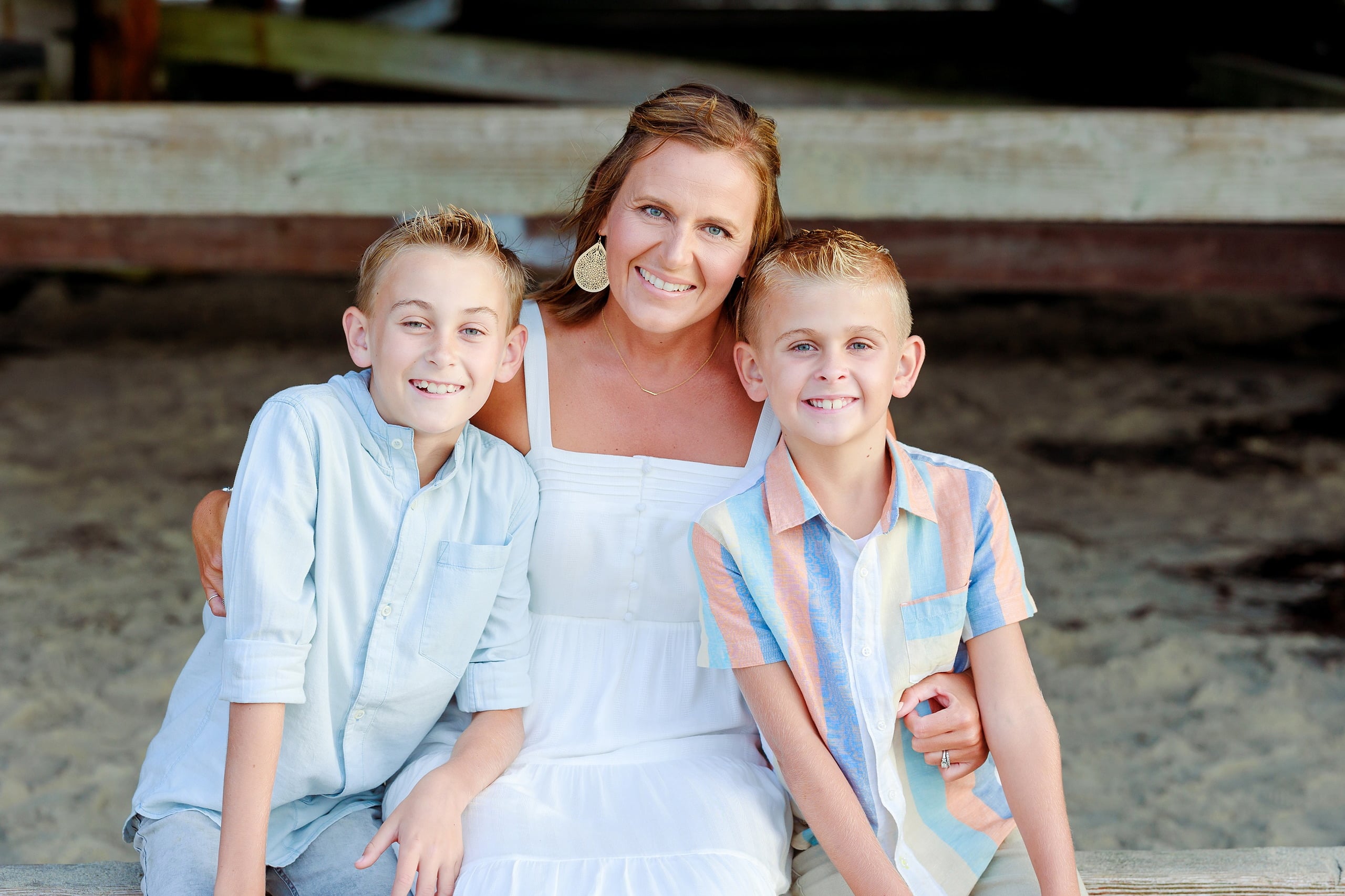 Butlers on the Beach — 05 Woman in white dress with two boys standing at water's edge under Crystal Pier