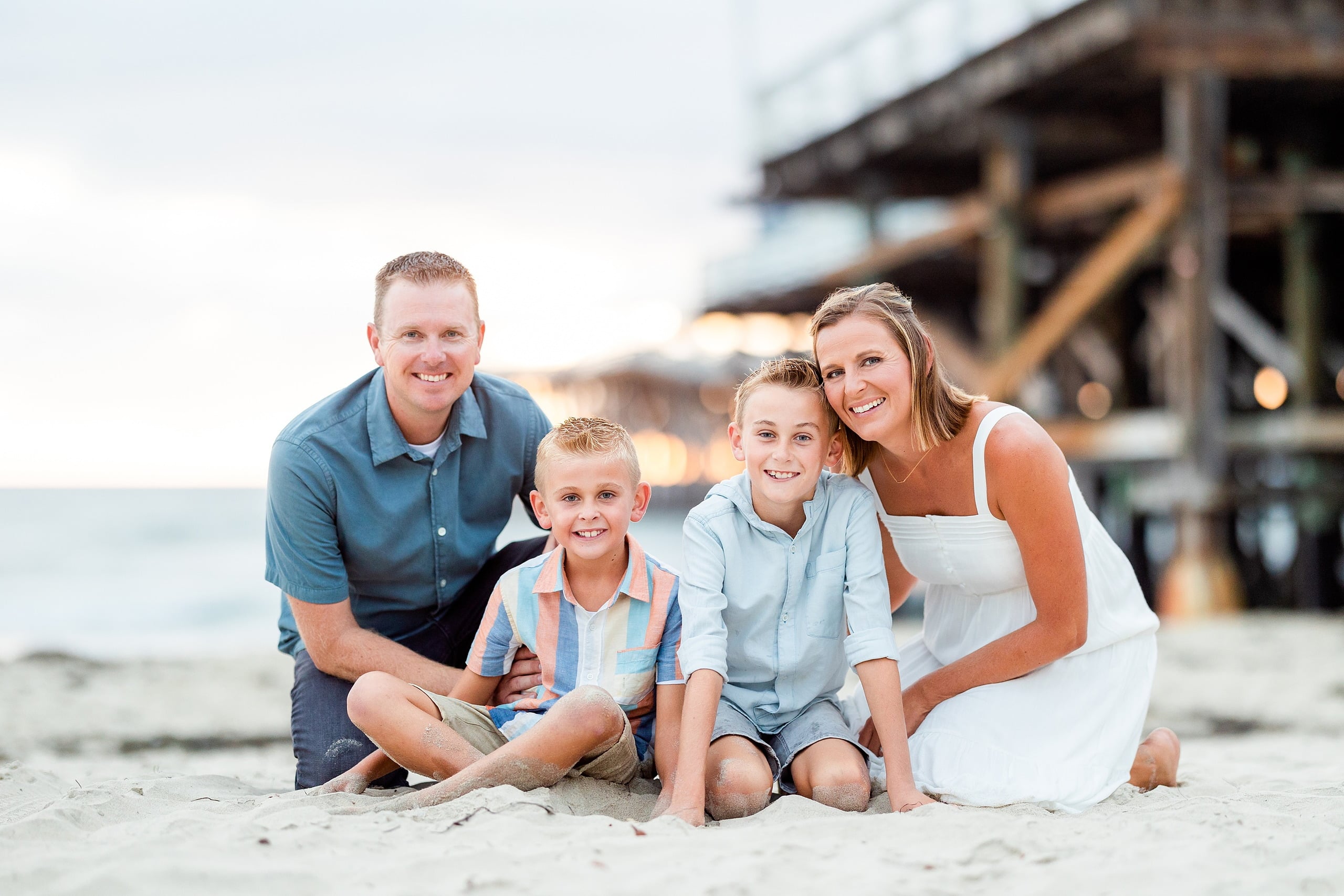 Butlers on the Beach — 24 The Butler family of four sitting together in sand at Crystal Pier