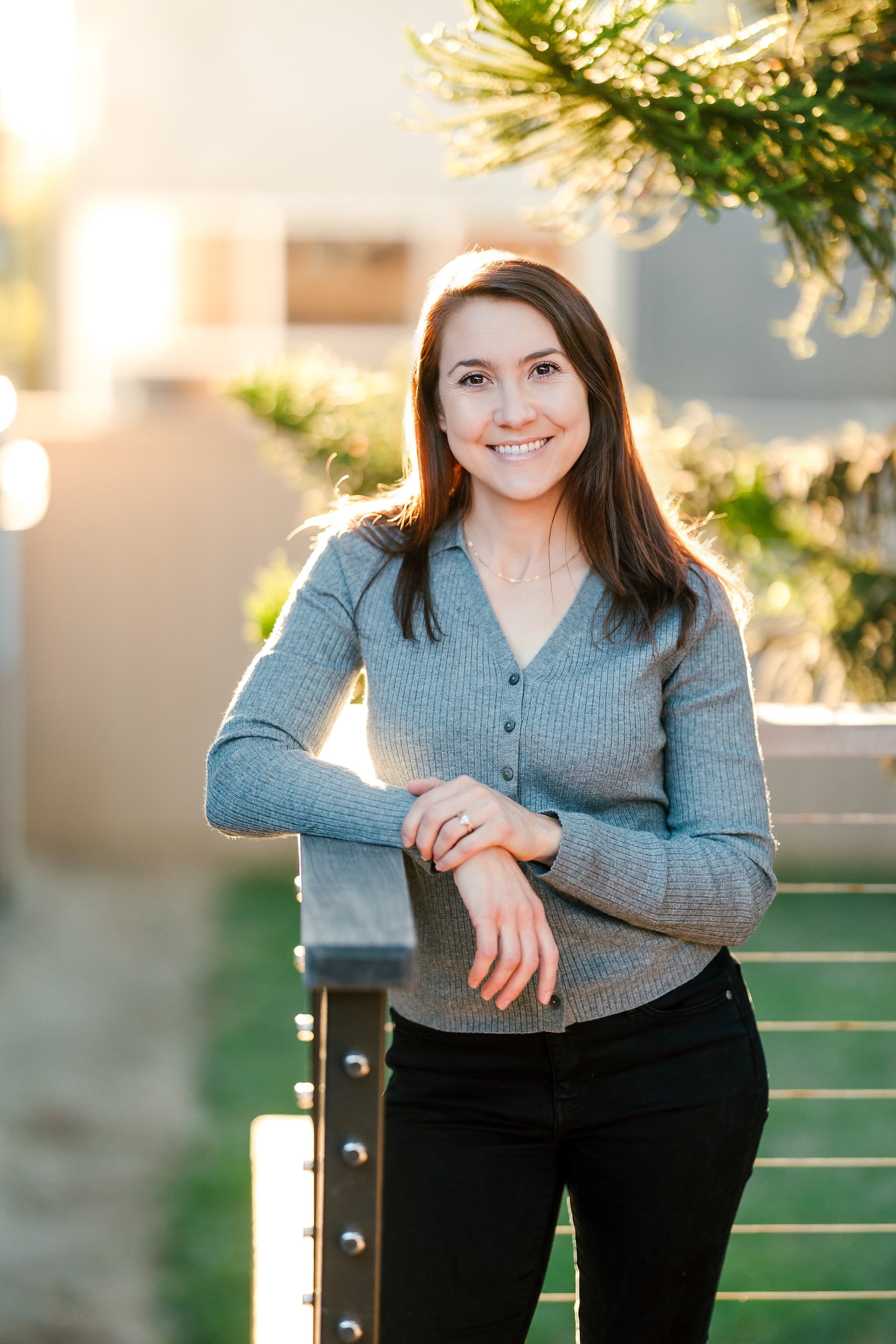 Capturing San Diego Spirit: Intention 2 Impact’s Team Retreat at Windansea — 24 Woman in ribbed cardigan standing outdoors in golden hour light