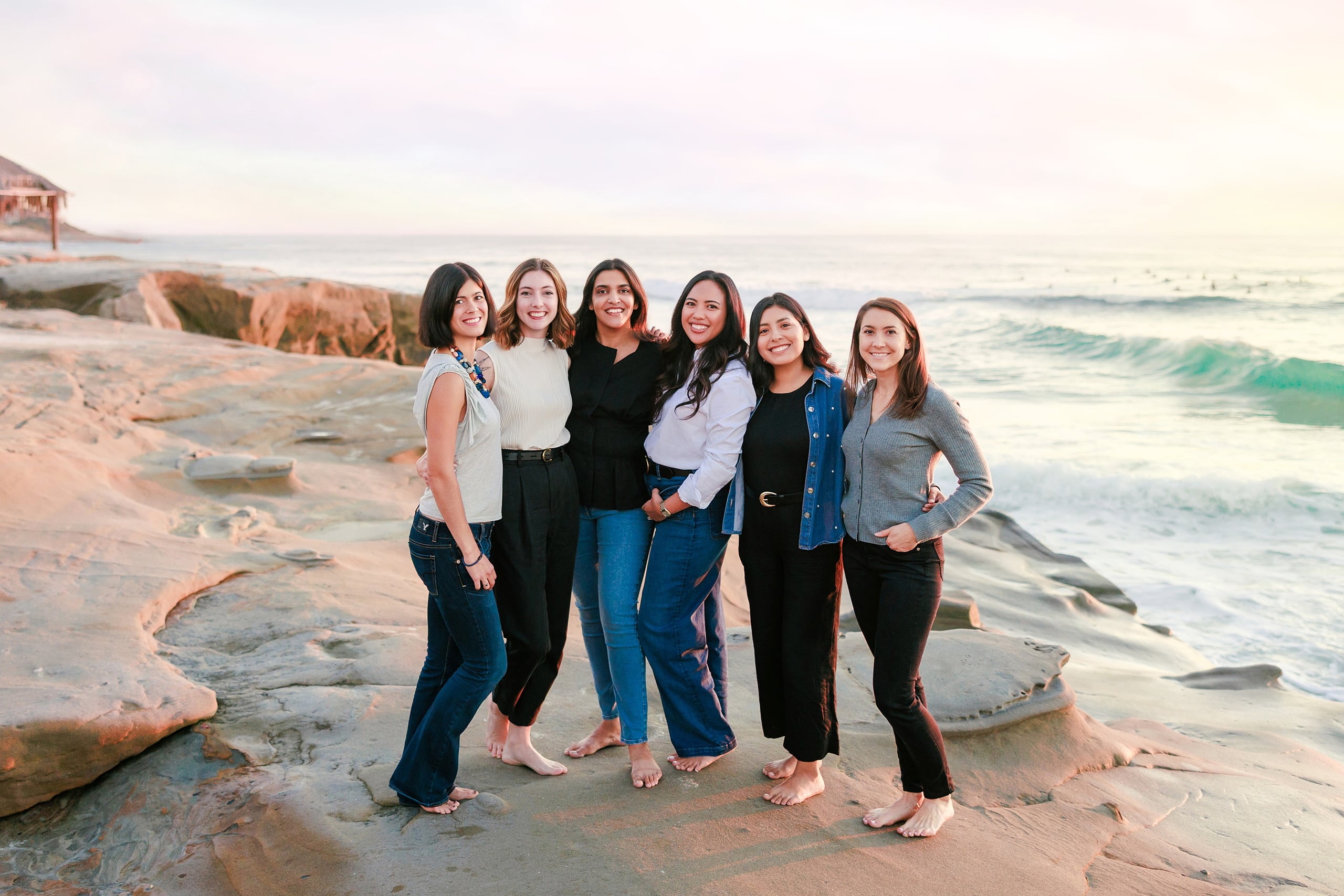 Capturing San Diego Spirit: Intention 2 Impact’s Team Retreat at Windansea — 32 Six women posing barefoot together on Windansea beach at golden hour
