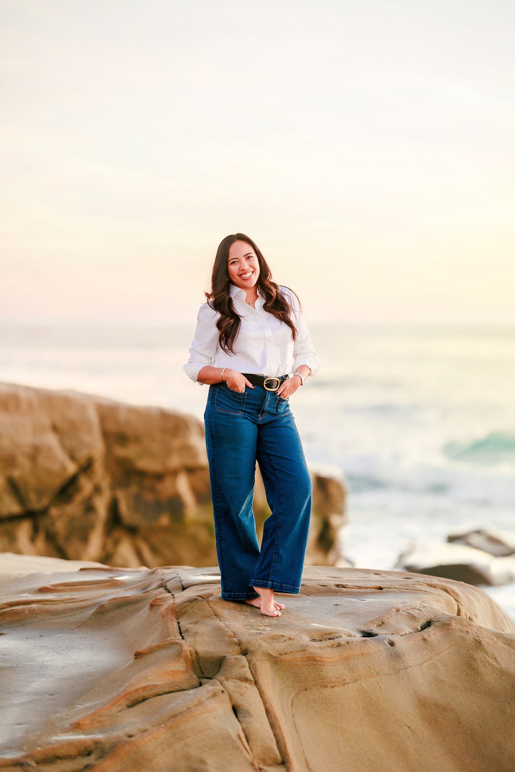 Capturing San Diego Spirit: Intention 2 Impact’s Team Retreat at Windansea — 39 Woman in black shirt standing barefoot on Windansea beach evening light