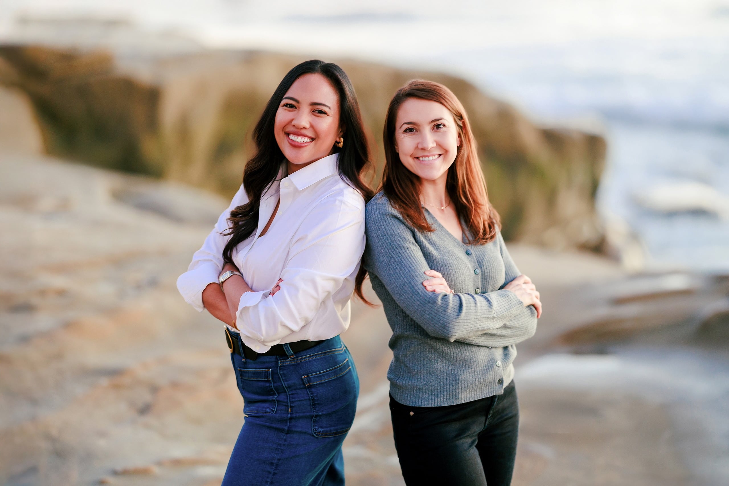 Capturing San Diego Spirit: Intention 2 Impact’s Team Retreat at Windansea — 41 Two women standing back-to-back on Windansea beach with rocky shore