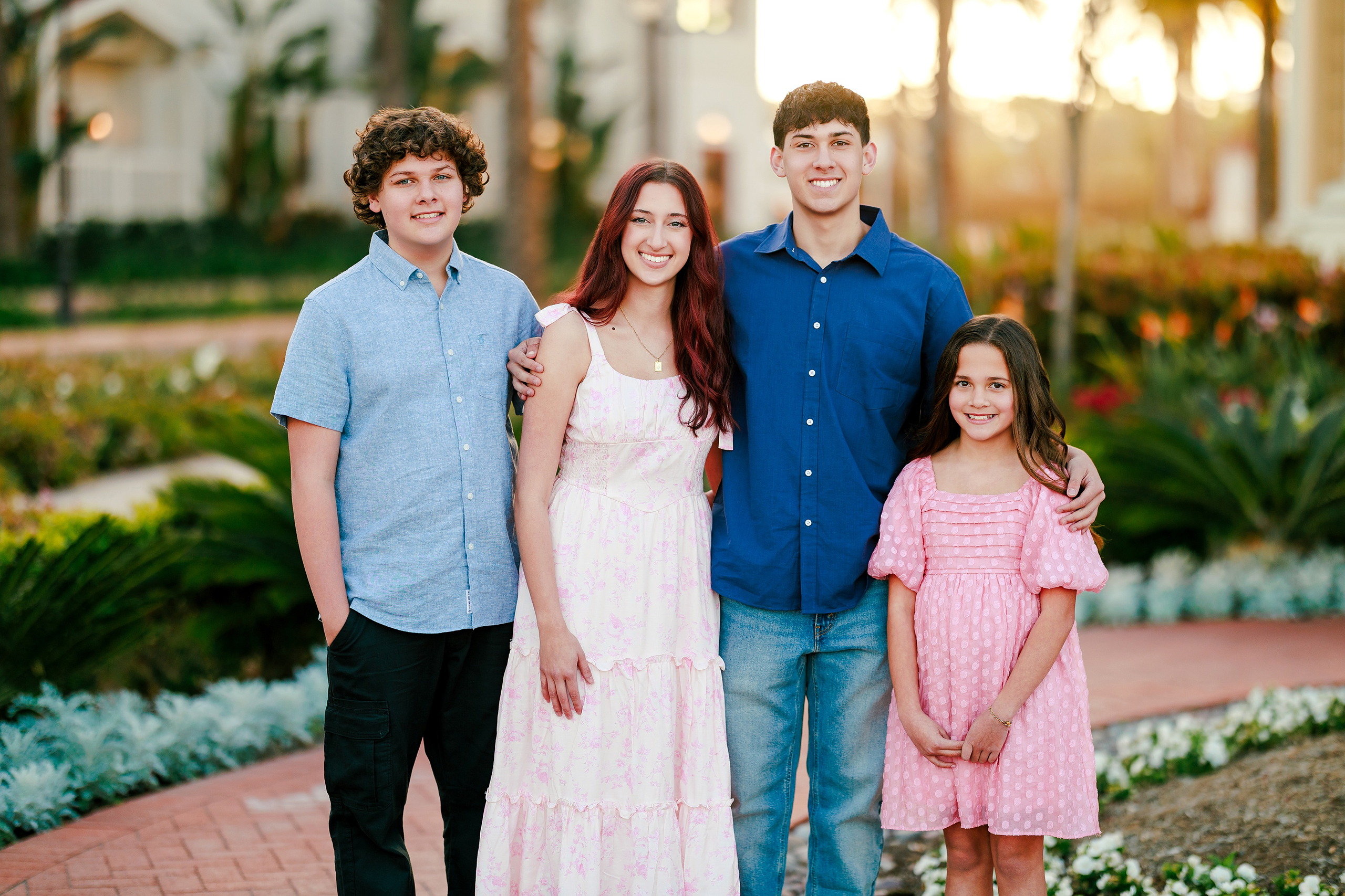 Coronado Beach Memories with the Sanchez Family — 06 Man in light blue patterned shirt with three children at Hotel del Coronado courtyard