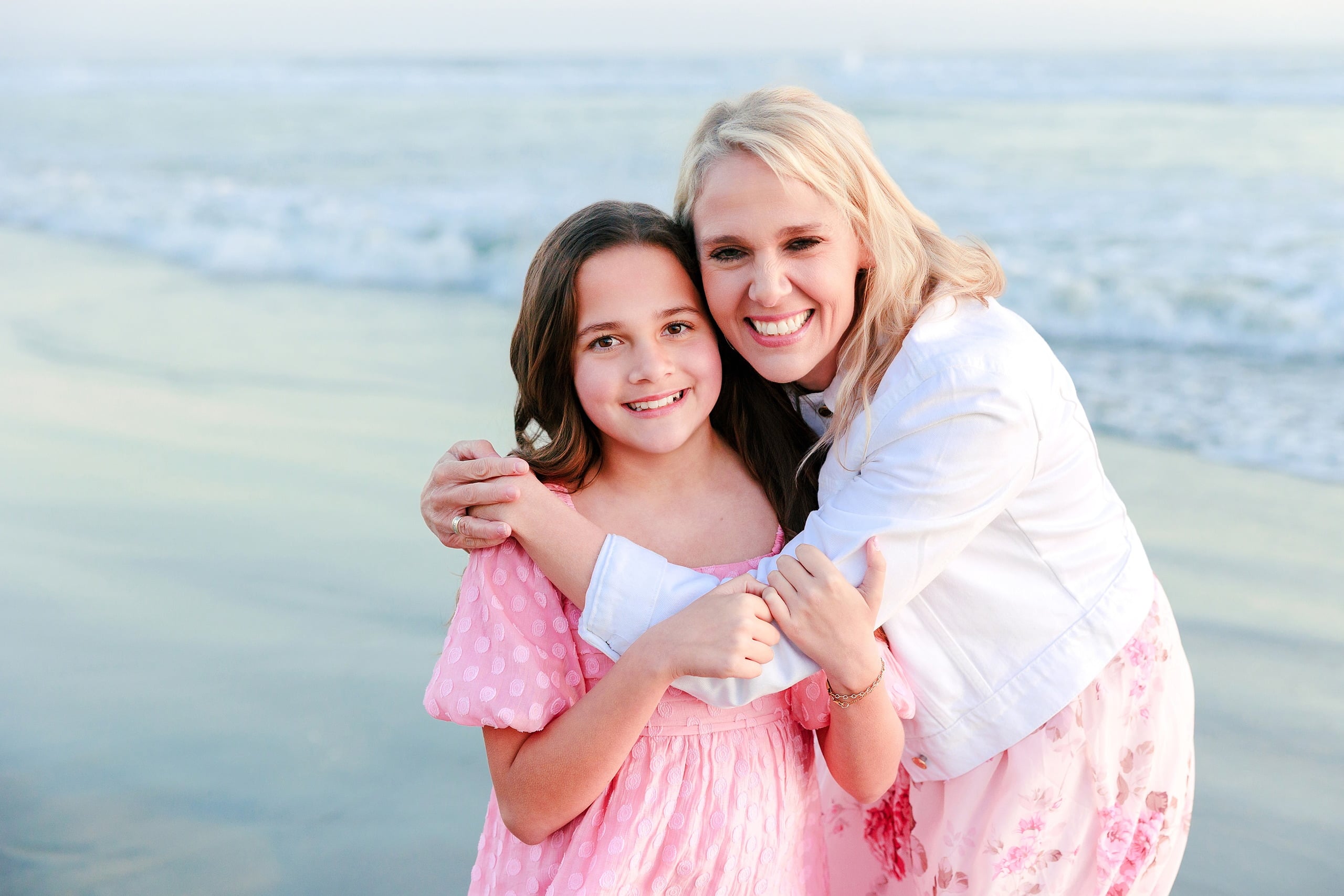 Coronado Beach Memories with the Sanchez Family — 18 Woman in white and girl in pink embracing on Coronado Beach
