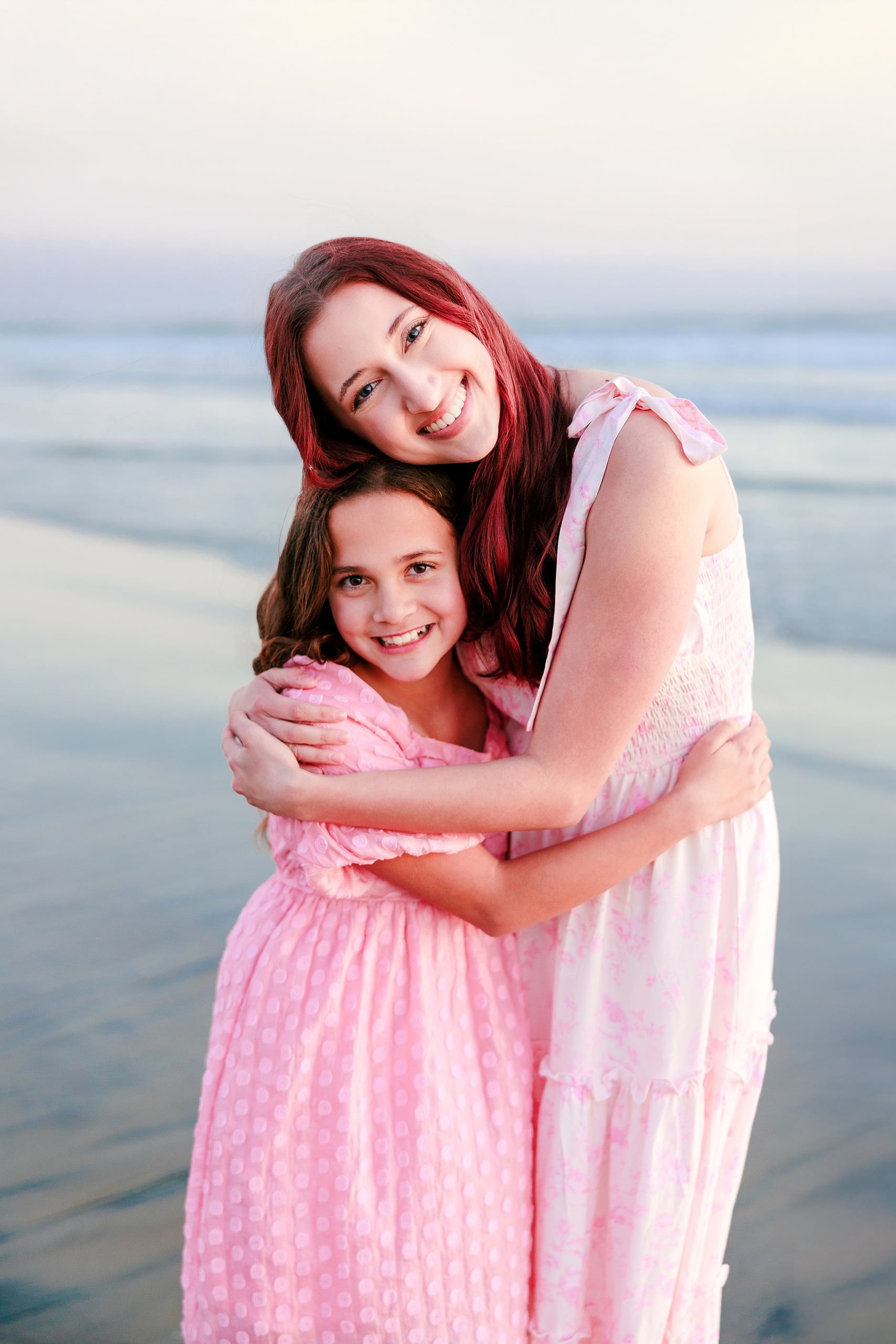 Coronado Beach Memories with the Sanchez Family — 21 Woman in pink sleeveless dress wading alone in shallow water on Coronado Beach