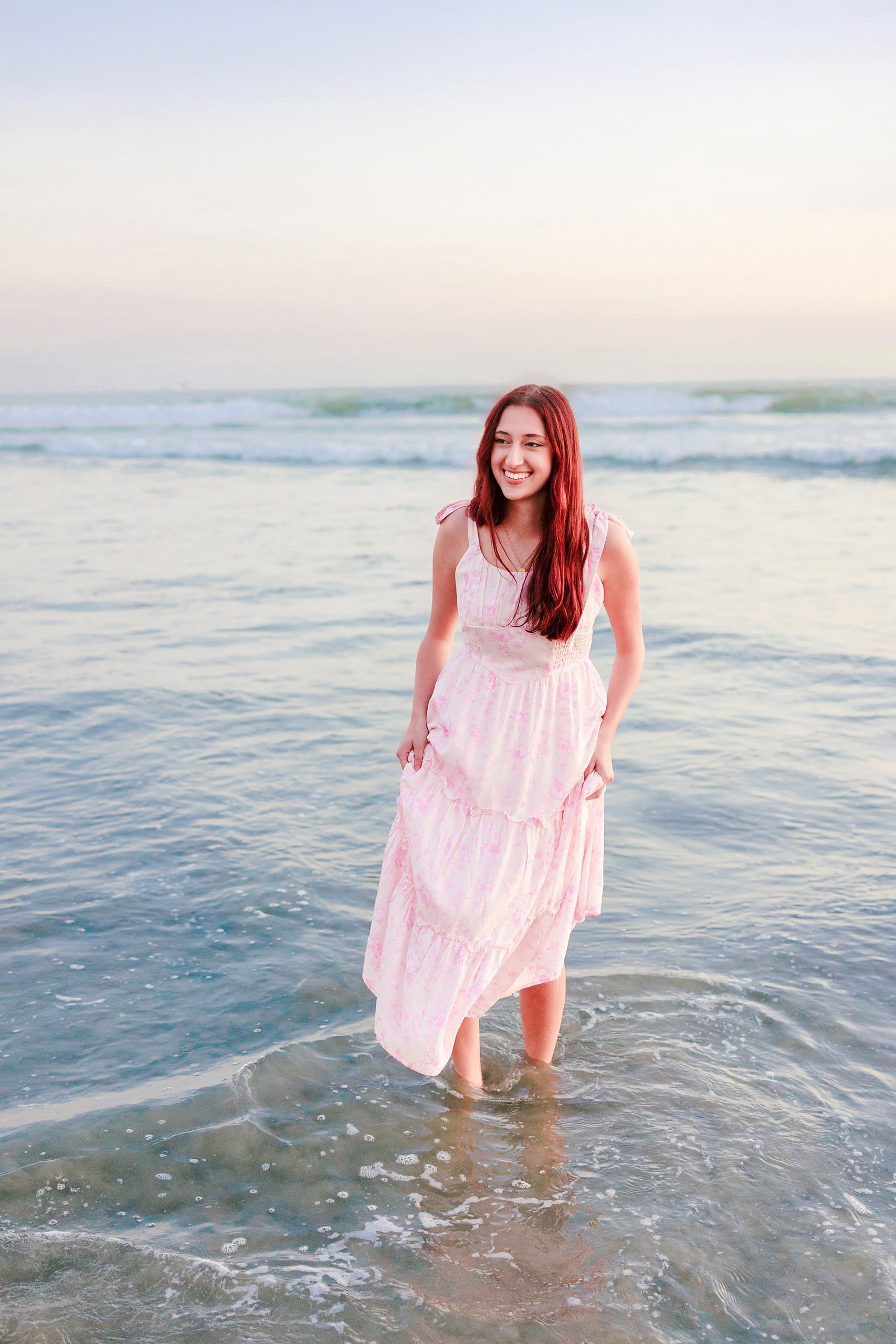 Coronado Beach Memories with the Sanchez Family — 23 Woman in pink sleeveless dress standing in shallow ocean water on Coronado Beach
