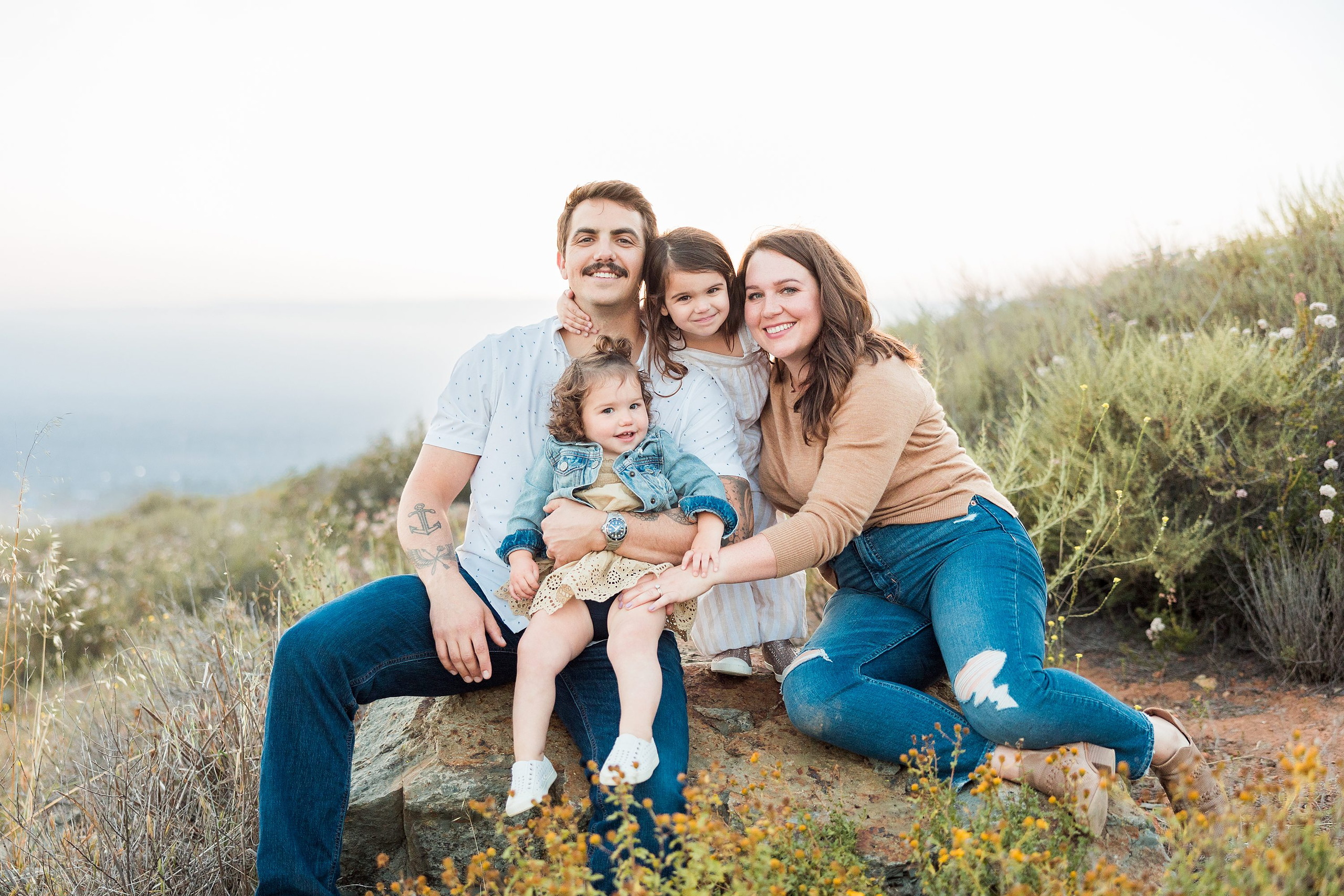Dictionary Hill Nature Trails Family Photography in San Diego — 01 Family of four sitting together on a rock at Dictionary Hill trails