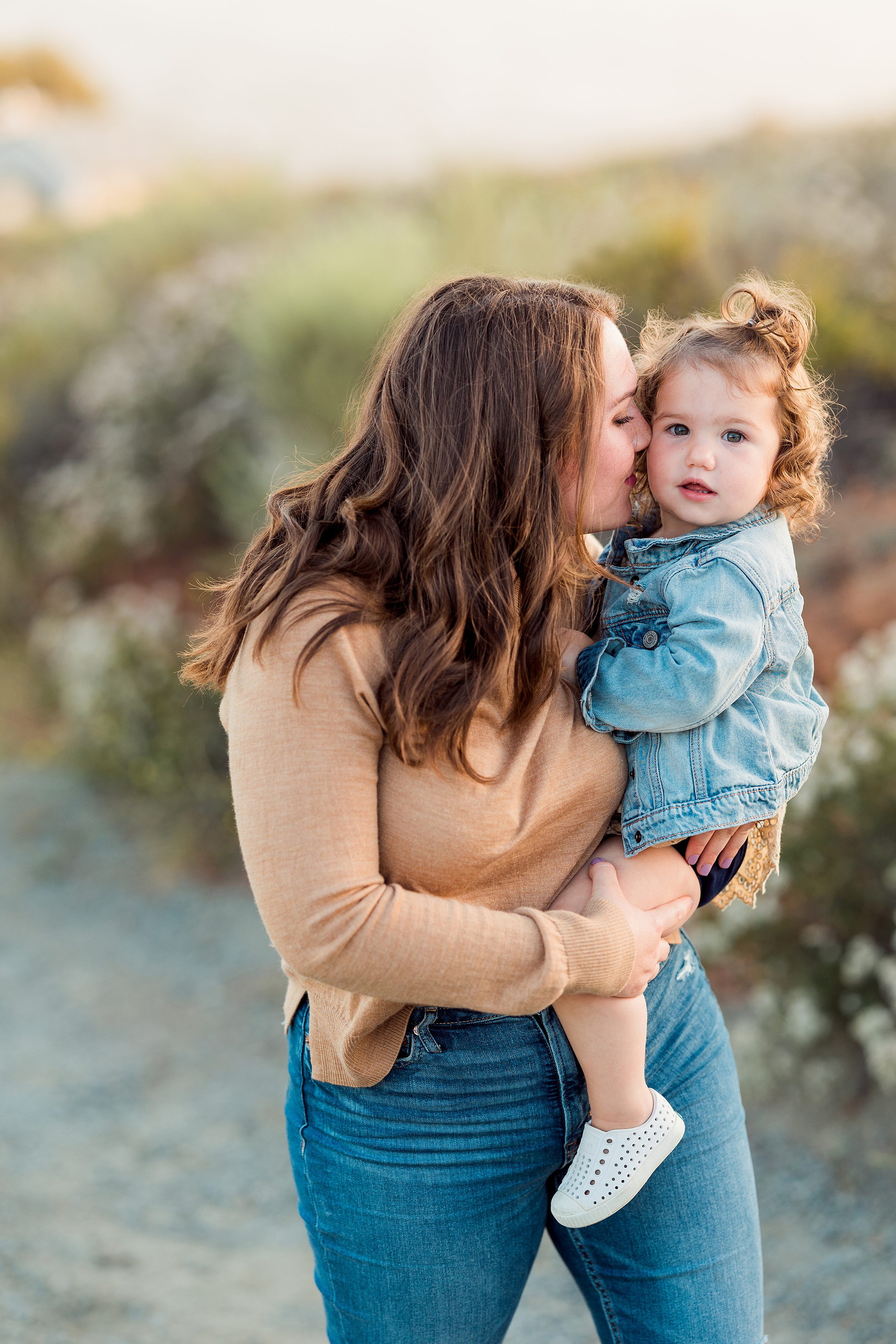 Dictionary Hill Nature Trails Family Photography in San Diego — 02 Woman holding toddler in blue denim jacket at Dictionary Hill