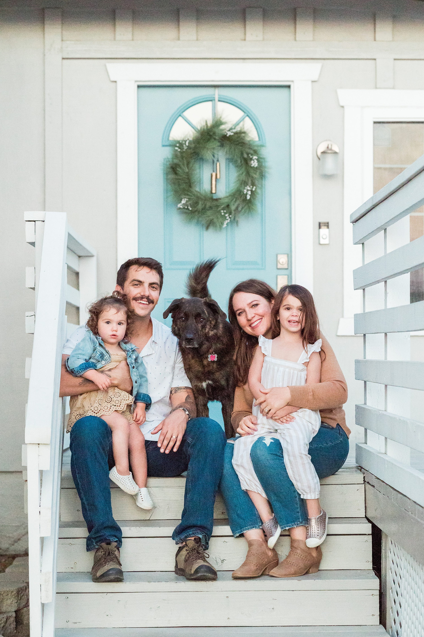 Dictionary Hill Nature Trails Family Photography in San Diego — 42 Family of four with dark dog sitting together on front porch steps