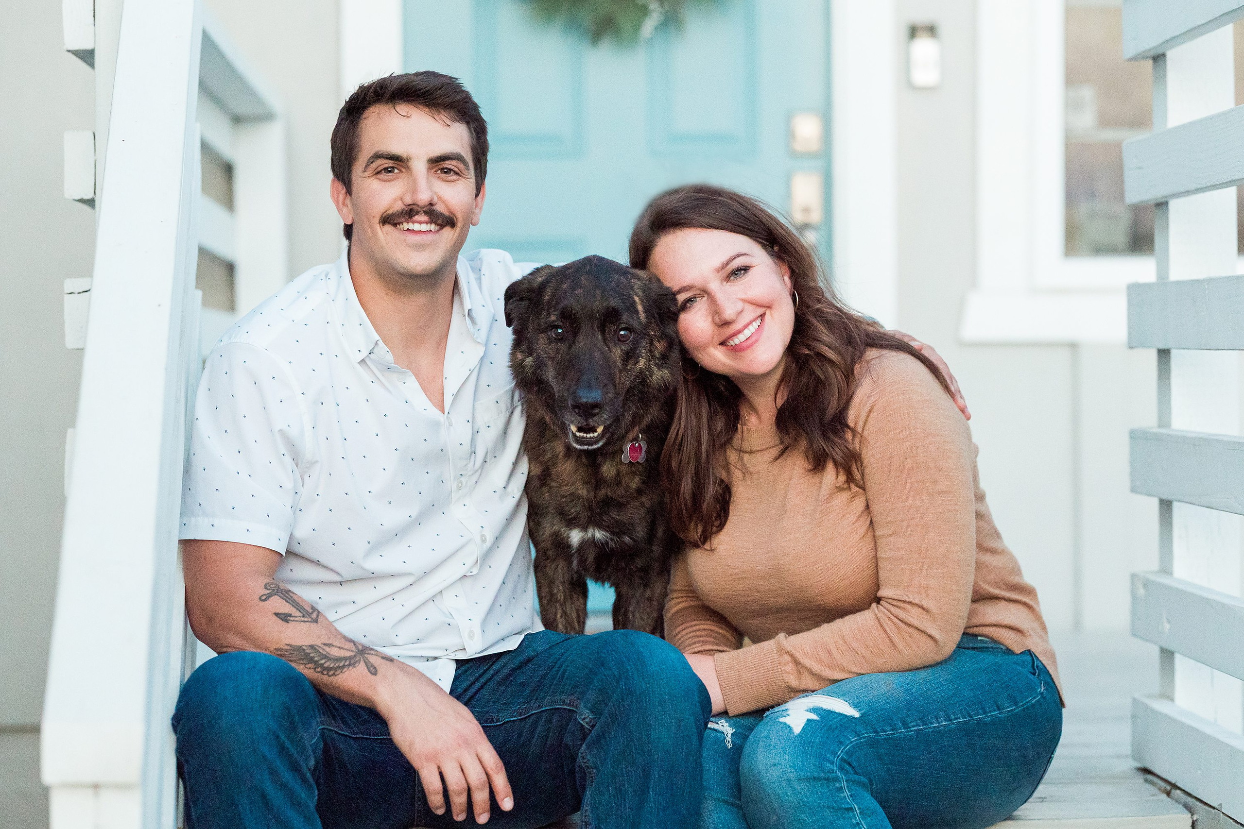 Dictionary Hill Nature Trails Family Photography in San Diego — 43 Couple posing with dark dog on white house front porch steps
