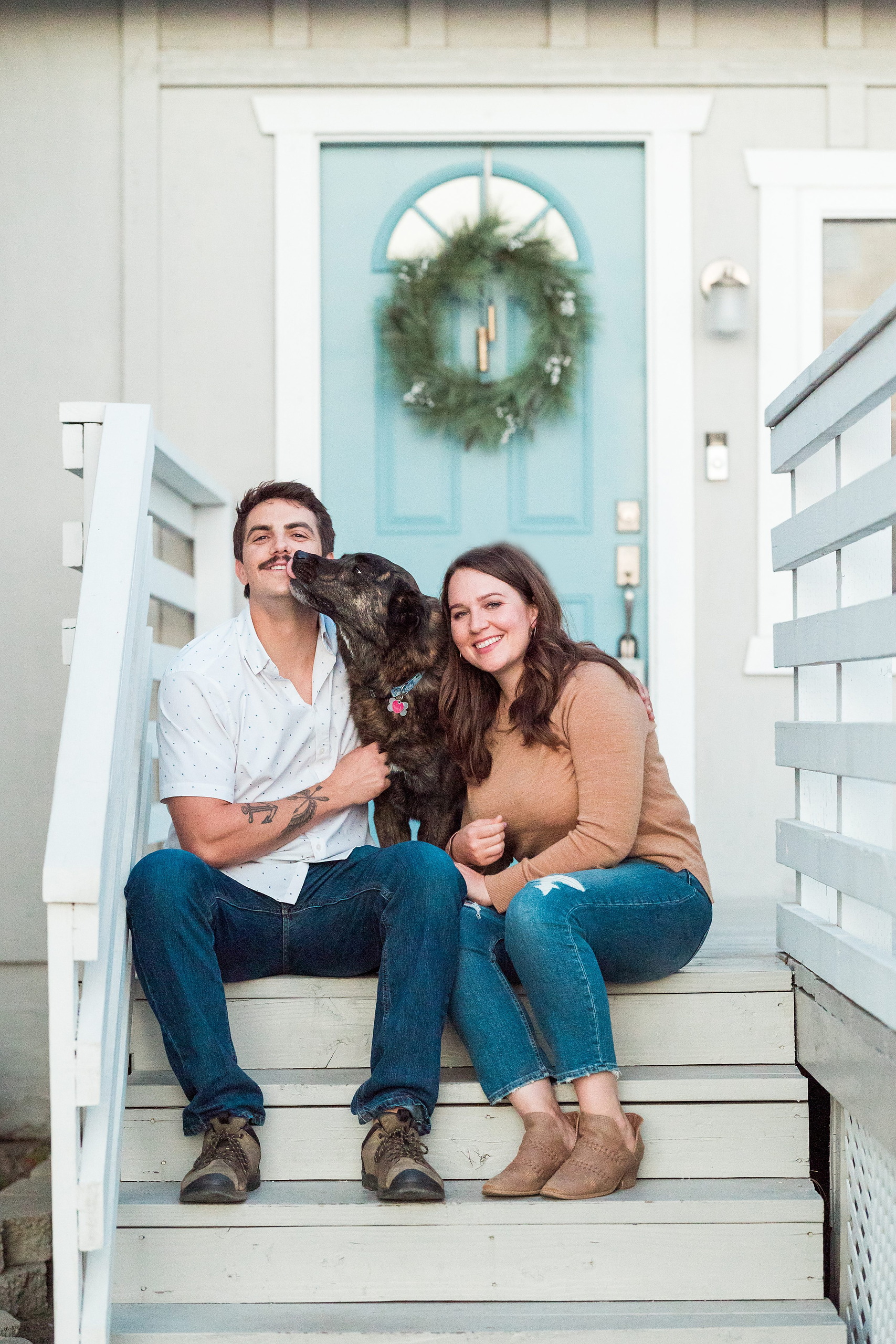 Dictionary Hill Nature Trails Family Photography in San Diego — 44 Couple with dog sitting on house steps with holiday wreath above
