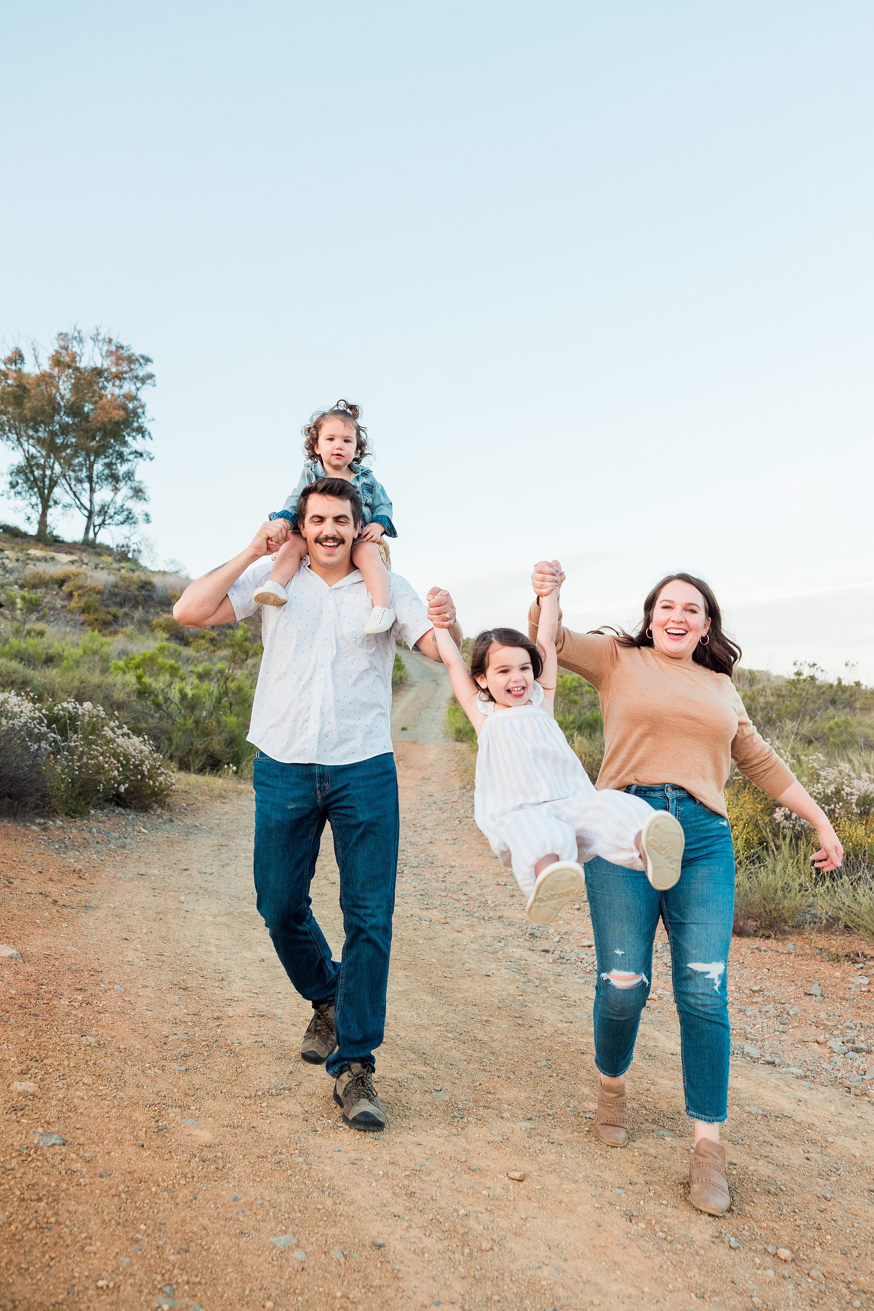 Dictionary Hill Nature Trails Family Photography in San Diego — 47 Family swinging toddler between parents on Dictionary Hill trail