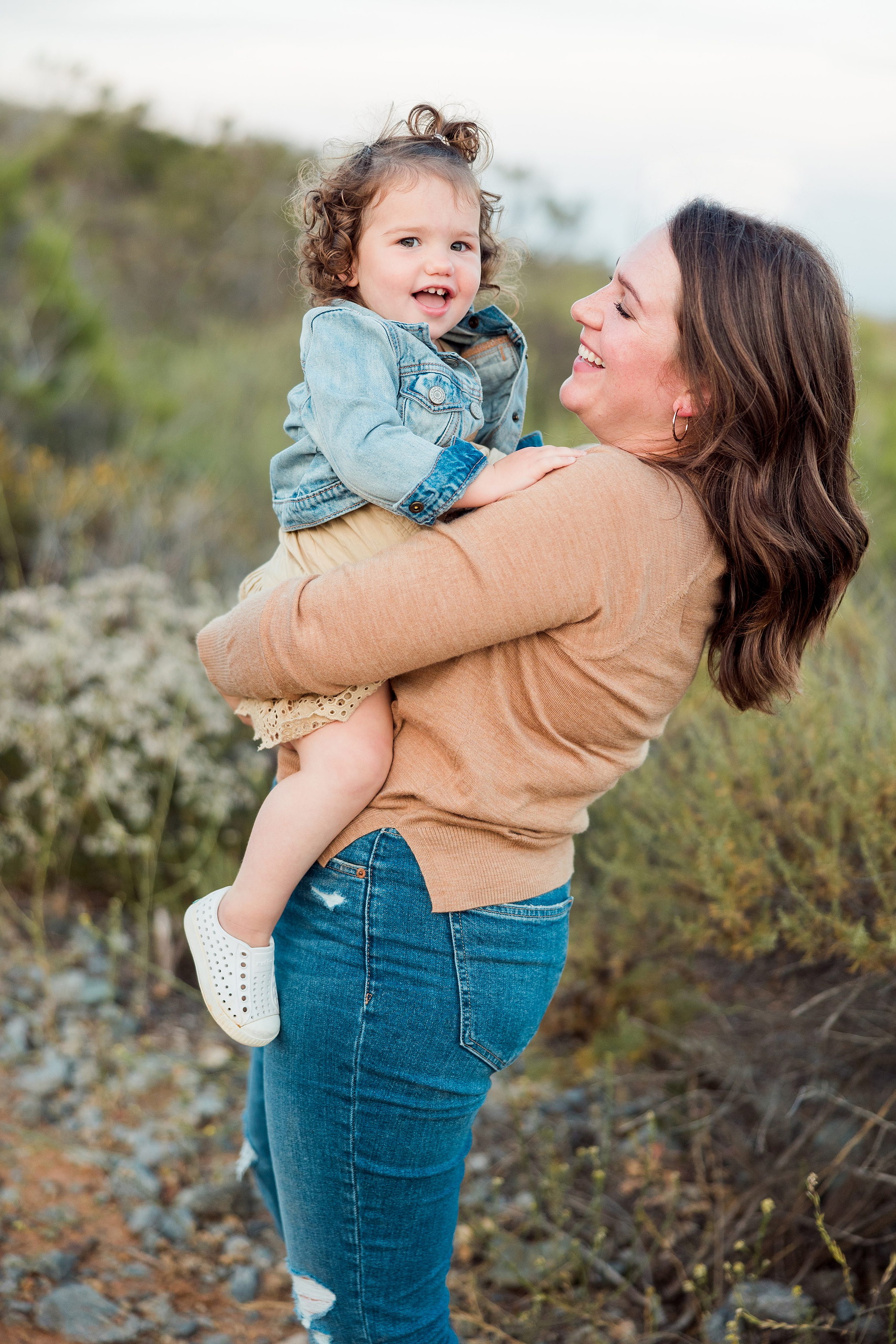 Dictionary Hill Nature Trails Family Photography in San Diego — 51 Woman holding laughing toddler in her arms on Dictionary Hill trail