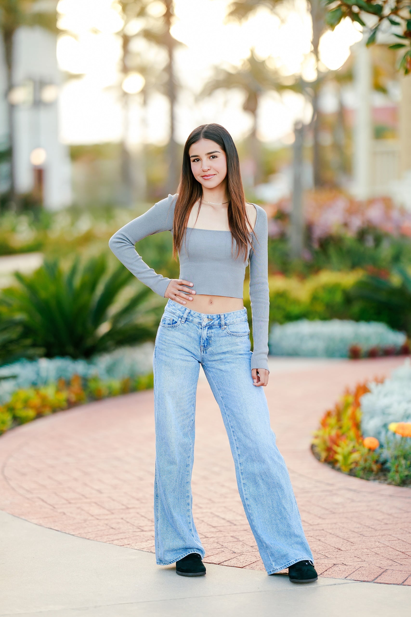 Evanna, Atalia, and Erleen’s Senior Session on Coronado — 09 Senior in light blue dress with cardigan standing at Hotel del Coronado