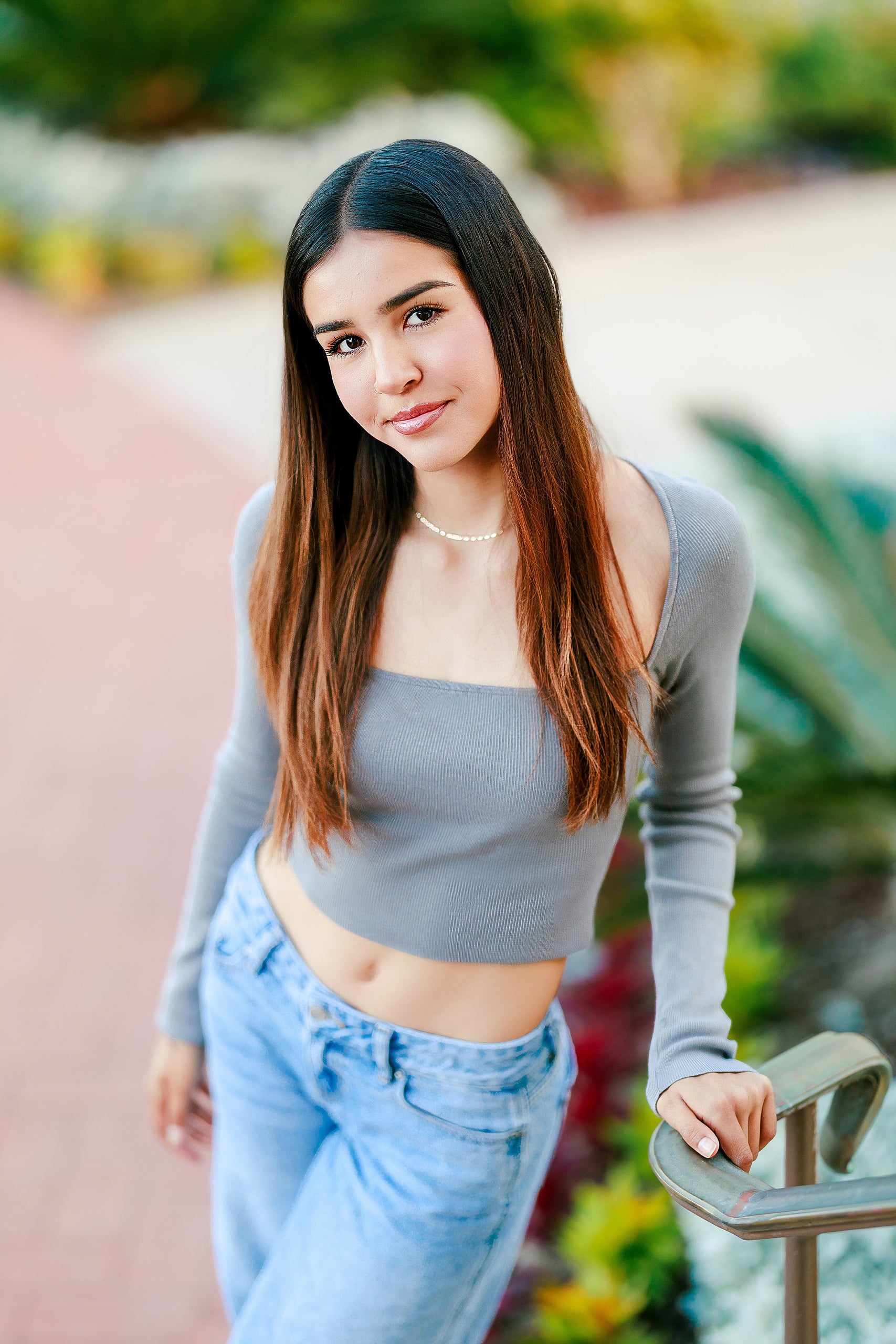 Evanna, Atalia, and Erleen’s Senior Session on Coronado — 11 Senior in lavender crop top and jeans at Coronado hotel courtyard