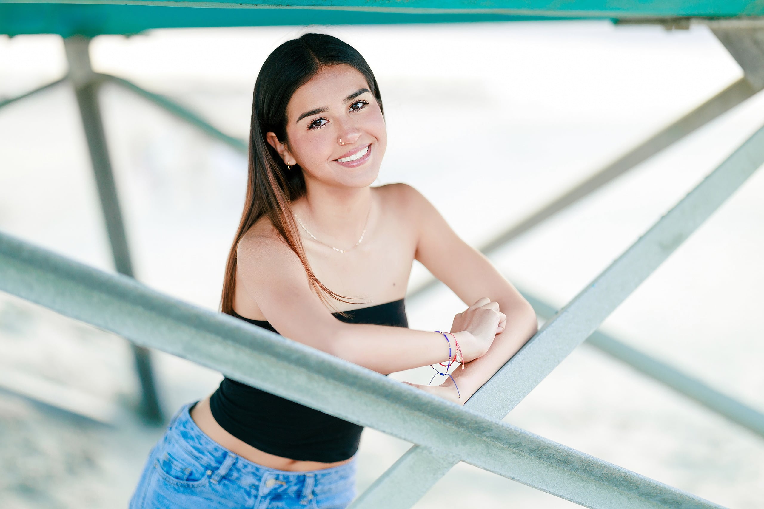 Evanna, Atalia, and Erleen’s Senior Session on Coronado — 15 Senior in black crop top on turquoise-painted pier at Coronado beach