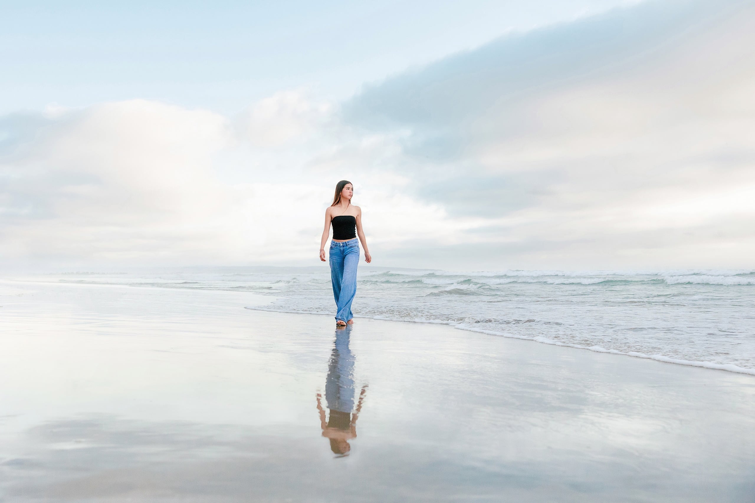 Evanna, Atalia, and Erleen’s Senior Session on Coronado — 29 Senior in black crop top wading into ocean at Coronado beach