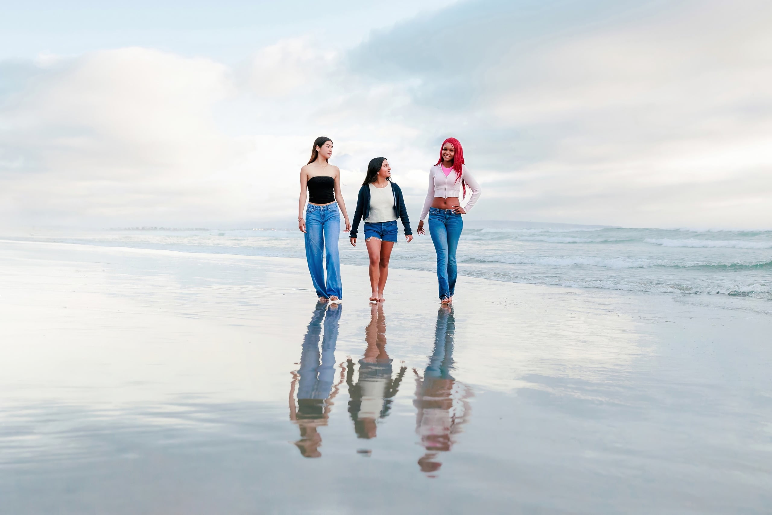 Evanna, Atalia, and Erleen’s Senior Session on Coronado — 30 Three seniors walking holding hands into ocean at Coronado shore