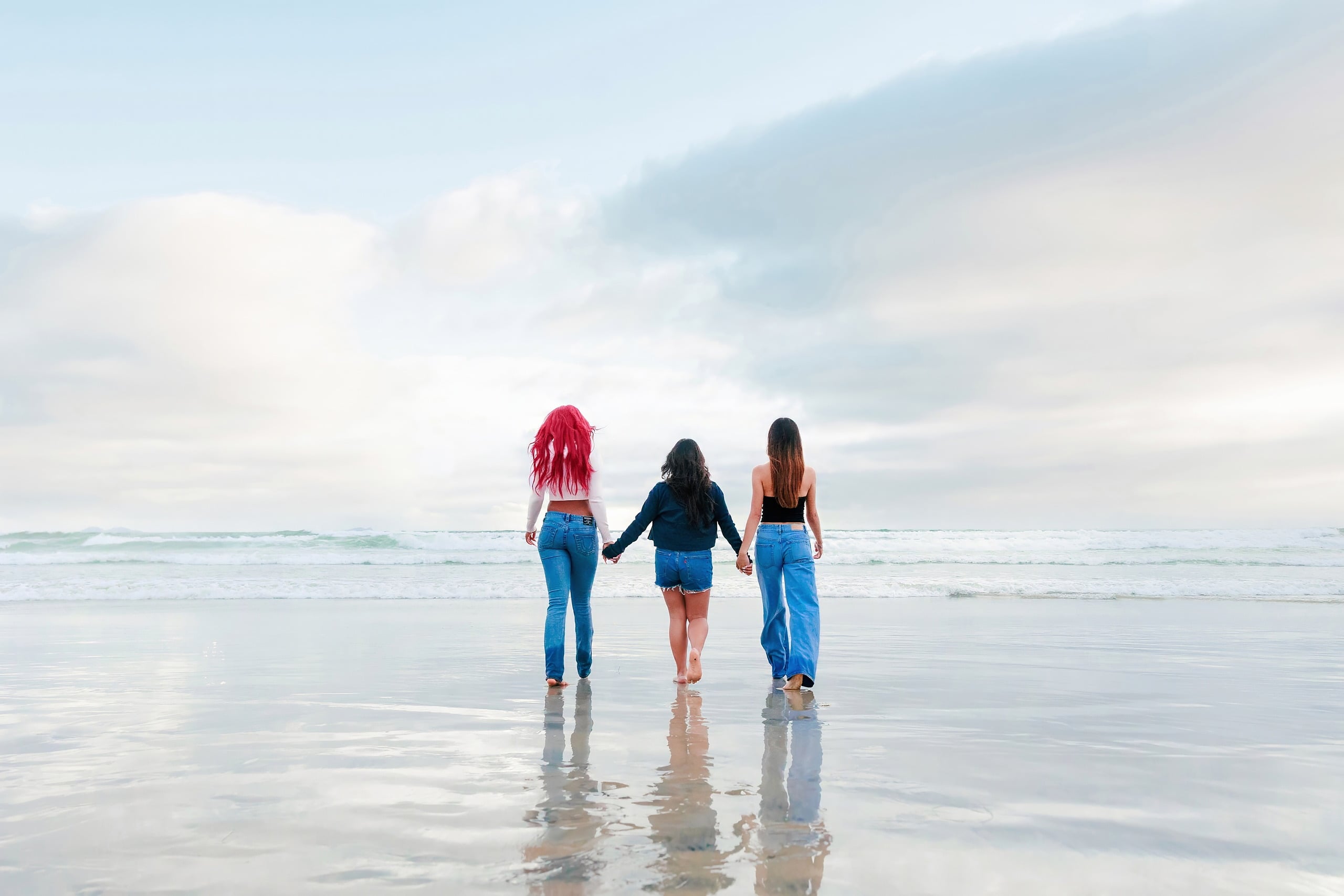 Evanna, Atalia, and Erleen’s Senior Session on Coronado — 33 Three seniors holding hands walking into ocean at Coronado