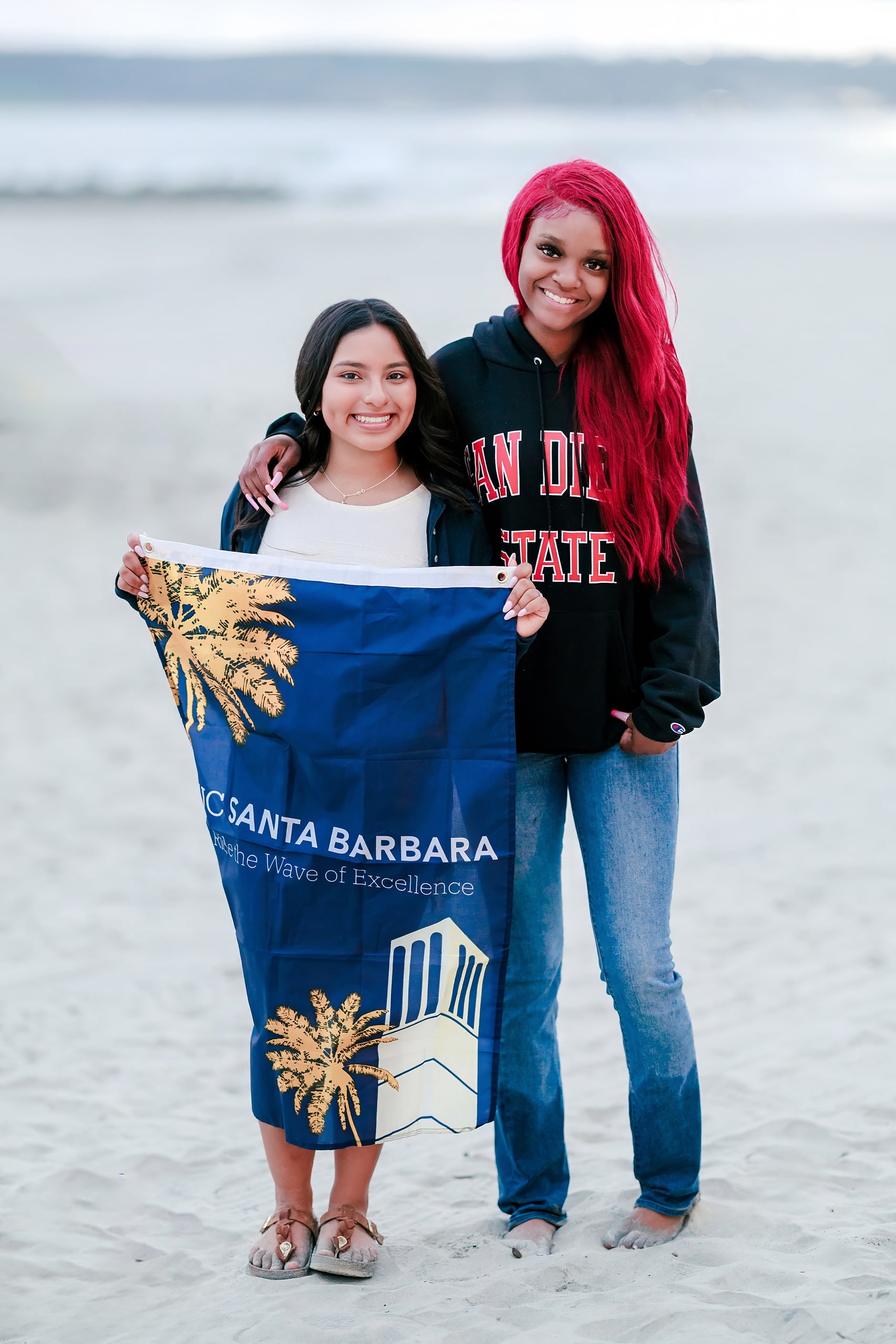 Evanna, Atalia, and Erleen’s Senior Session on Coronado — 35 Two seniors with UC Santa Barbara flag on beach at Coronado