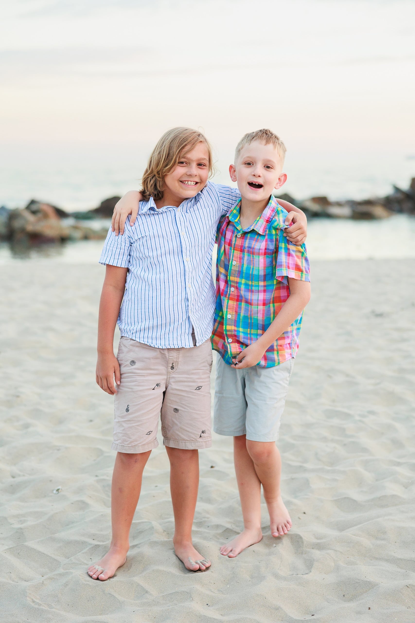 Extended Family Photography Hotel Del Coronado — 10 Two children stand close together on Coronado beach, both smiling brightly